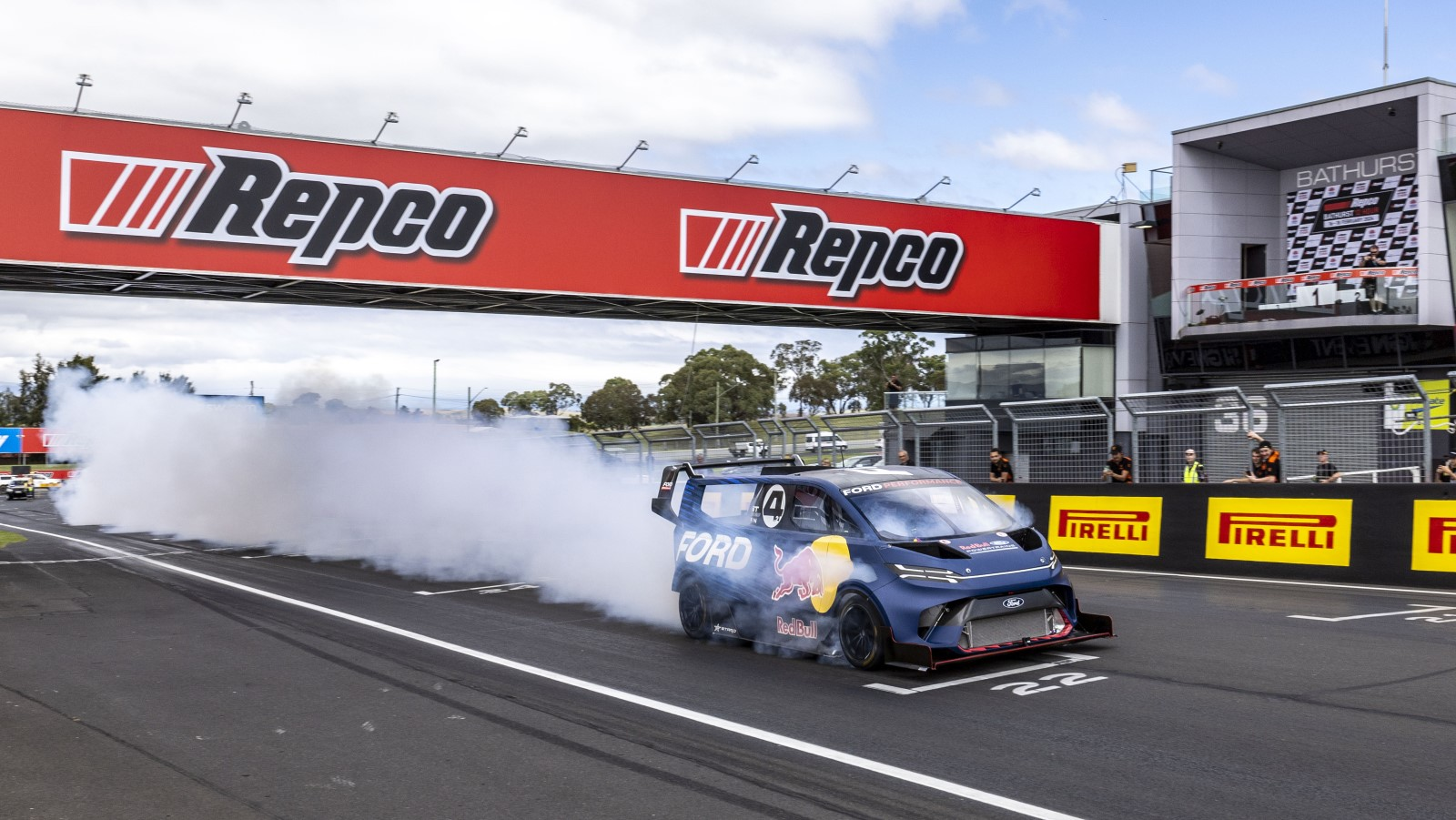 A photo of the Ford SuperVan racing on a track. 