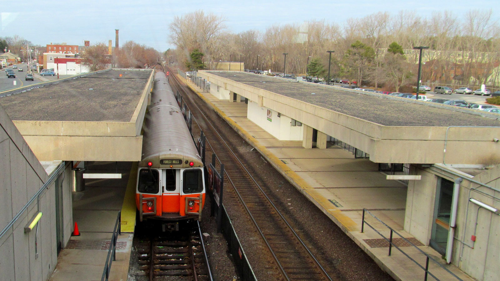 A photo of an Orange Line train pulling into a station in Boston. 