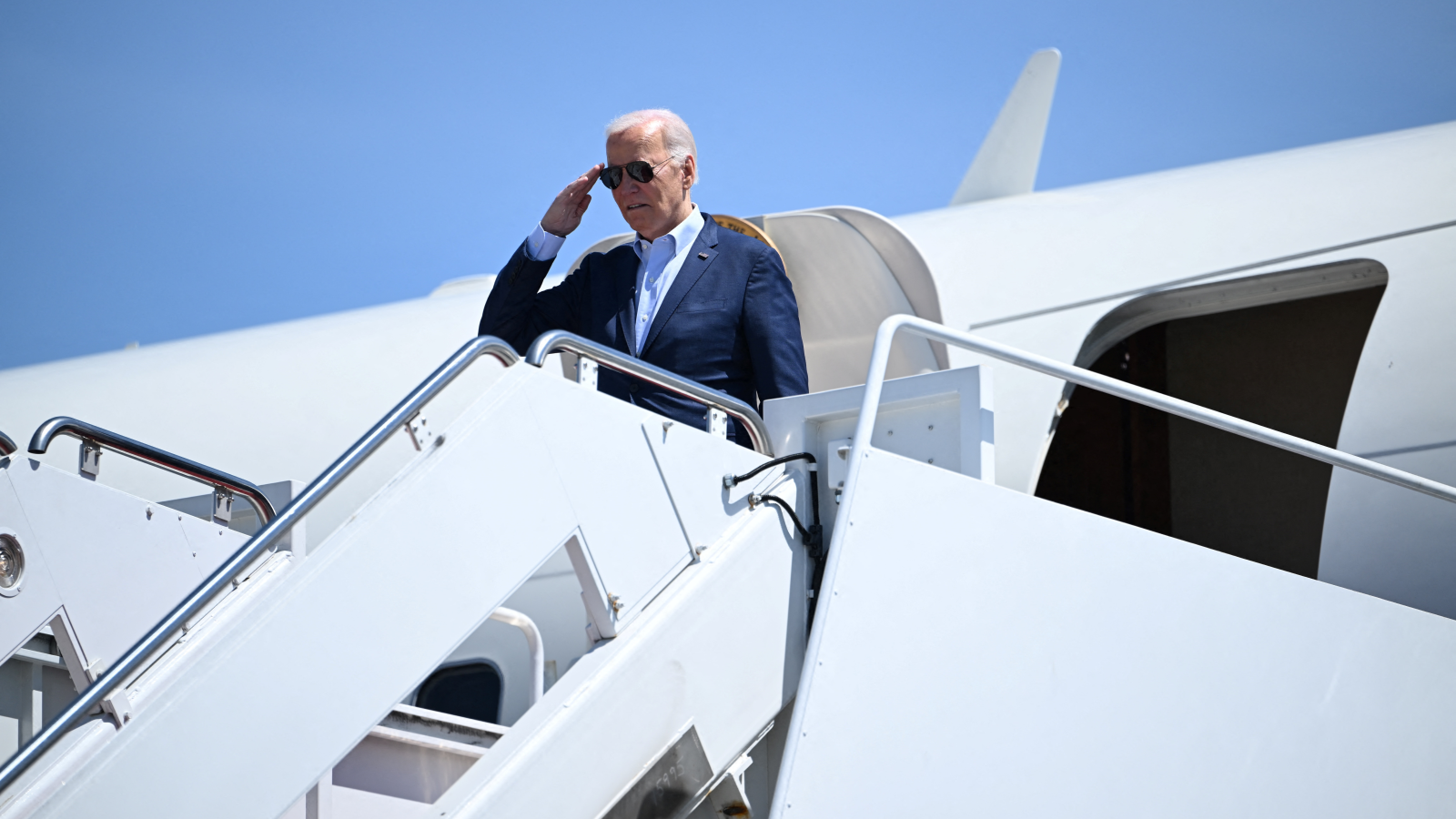 A photo of president Joe Biden getting off a plane. 