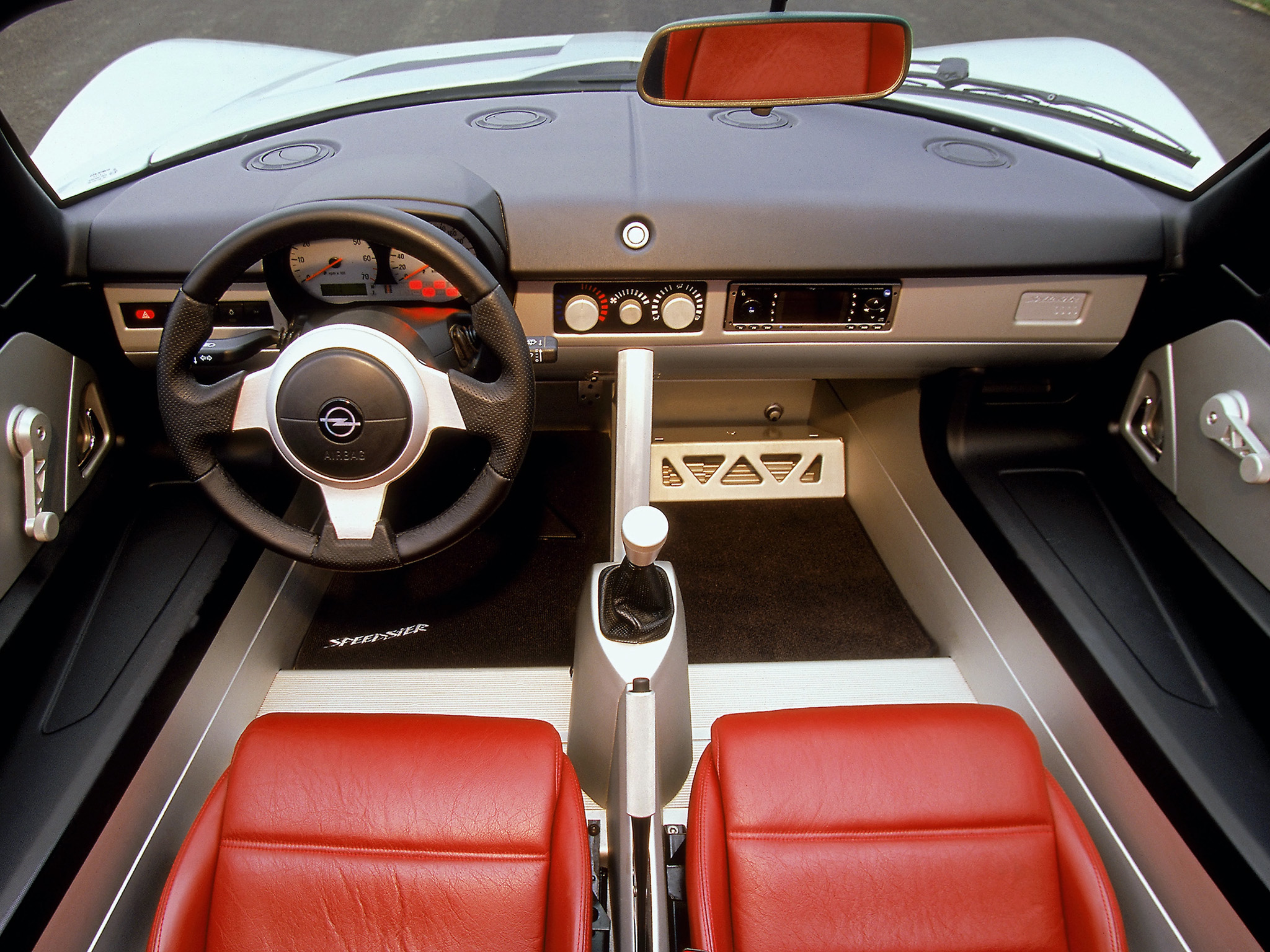 Dashboard view of an orange Opel Speedster