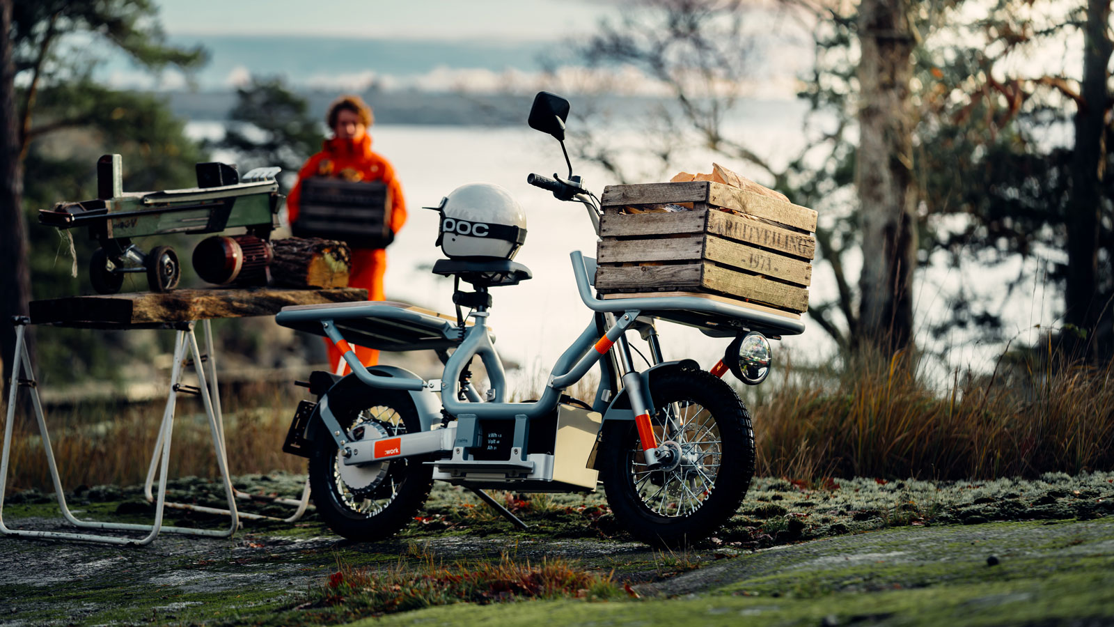 A Cake Makka :work electric moped parked by a lake 