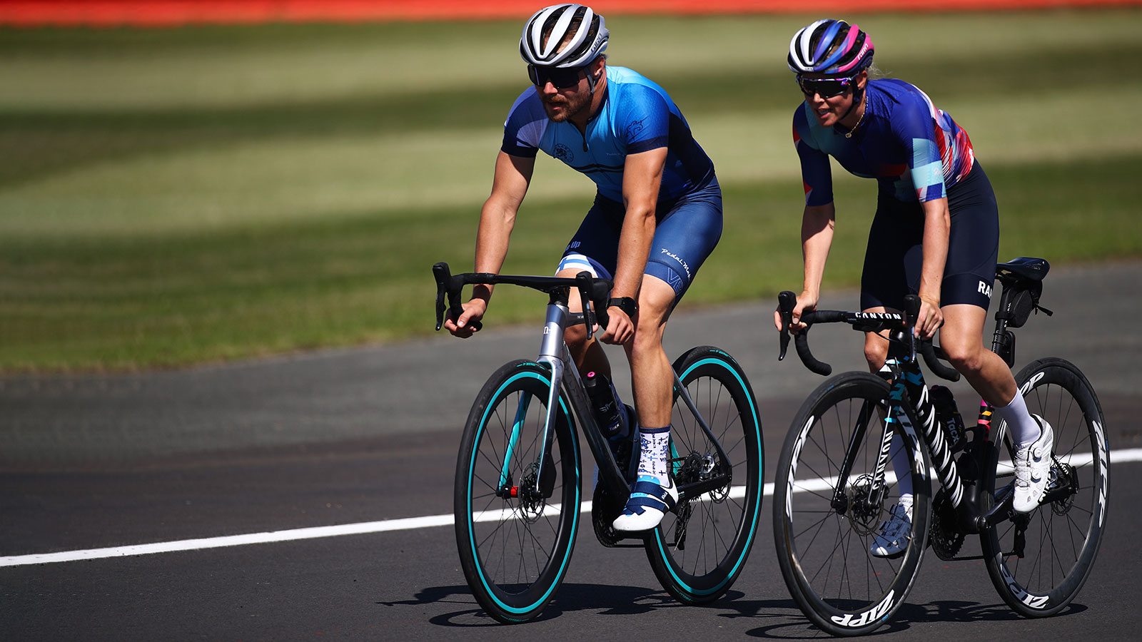 A photo of Valtteri Bottas and Tiffany Cromwell riding bikes. 