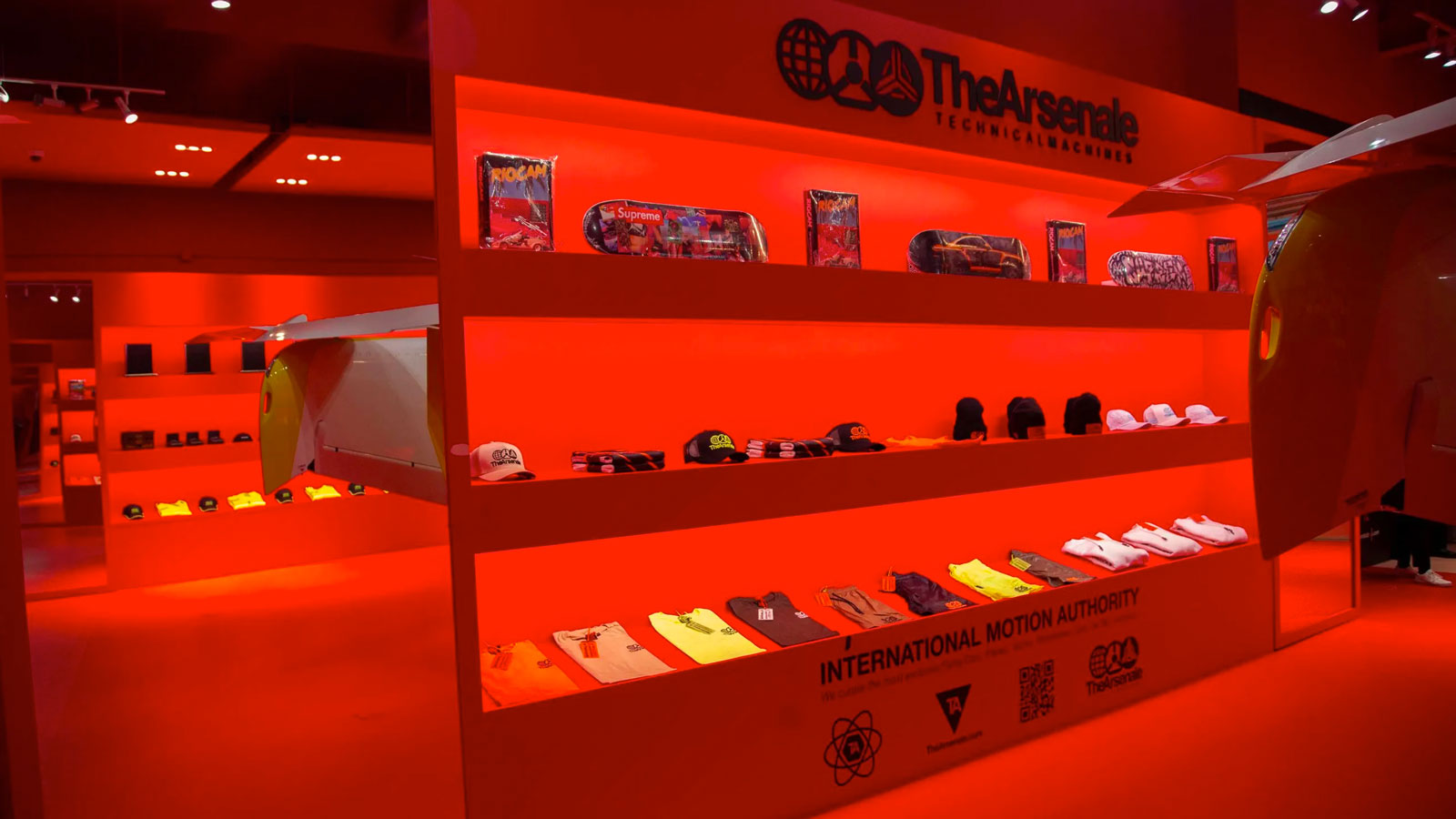 A display of baseball caps and t-shirts inside The Arsenale store. 