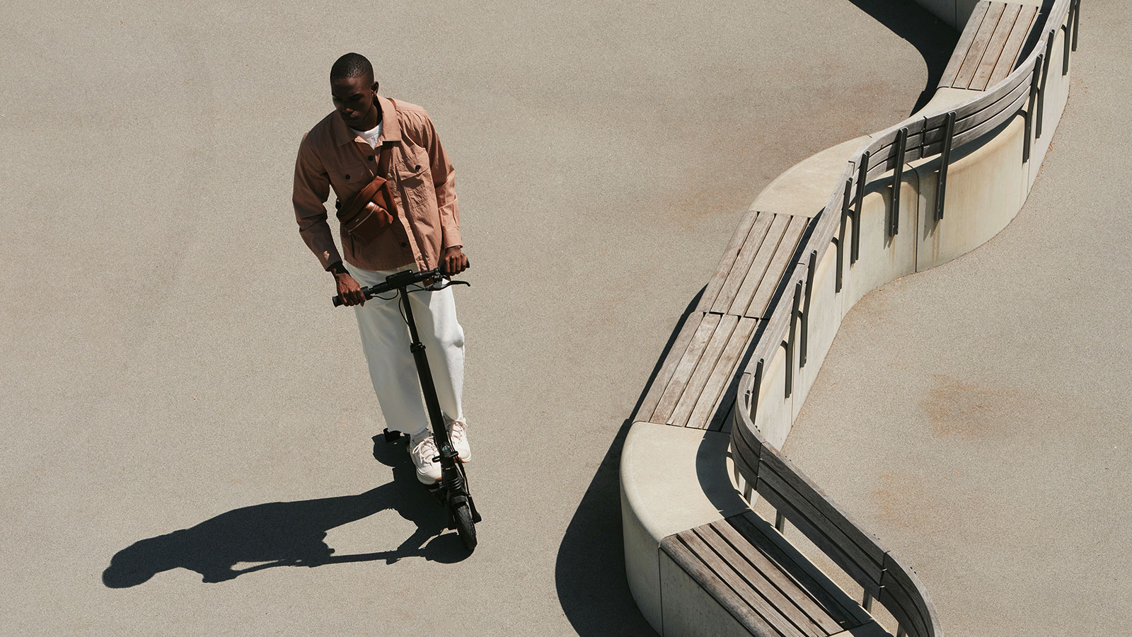 A photo of someone riding a Mercedes e-scooter. 