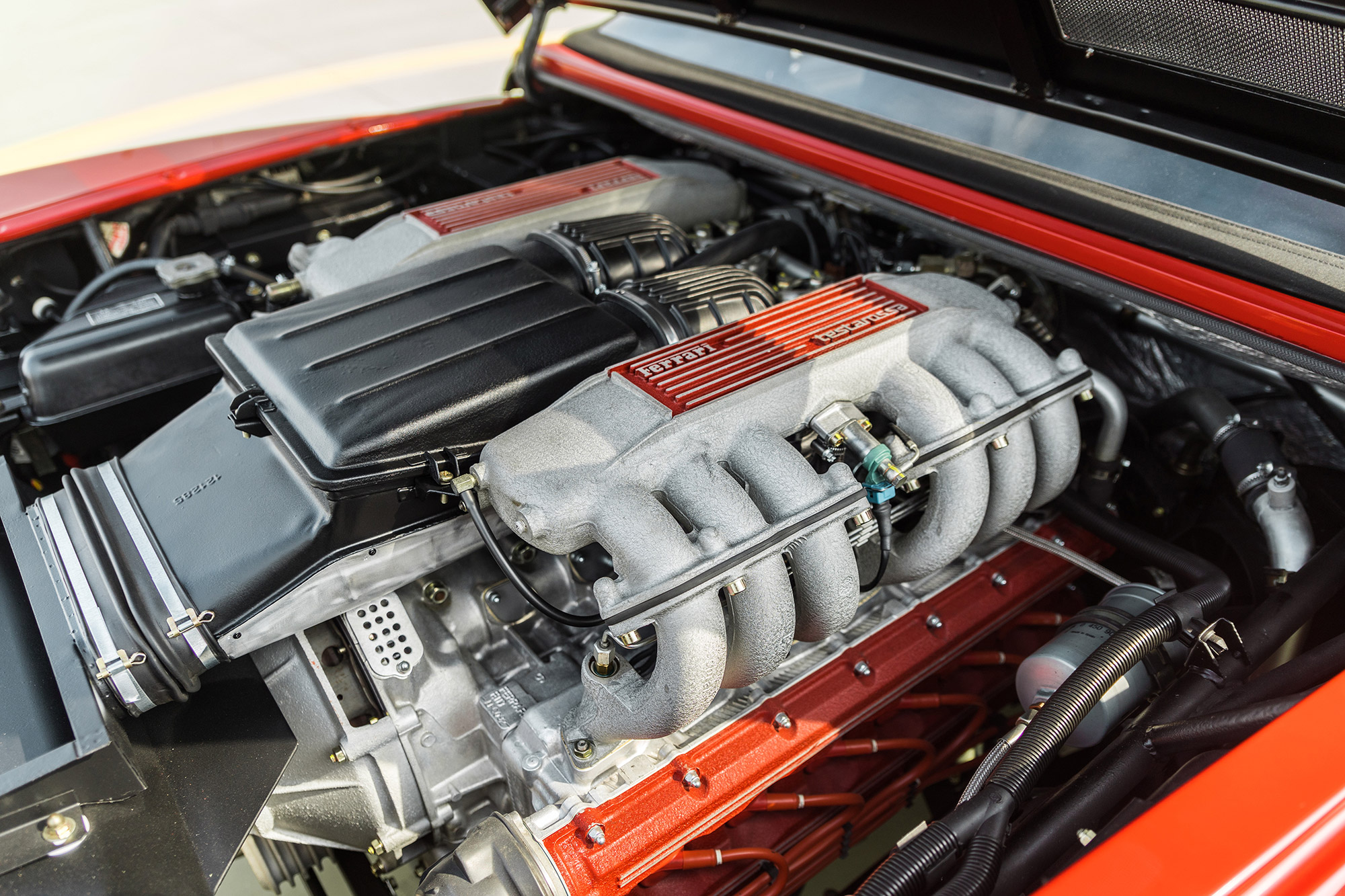 Engine bay of red Ferrari Testarossa Pininfarina Spider 