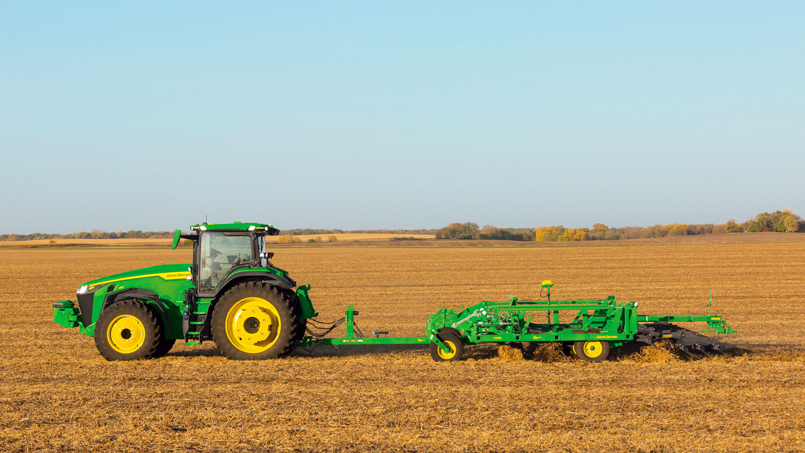 A profile photo of a John Deere tractor in a field. 