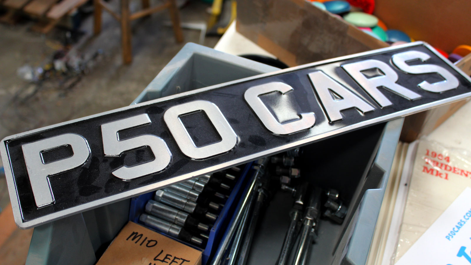 A photo of a black and silver number plate that reads 