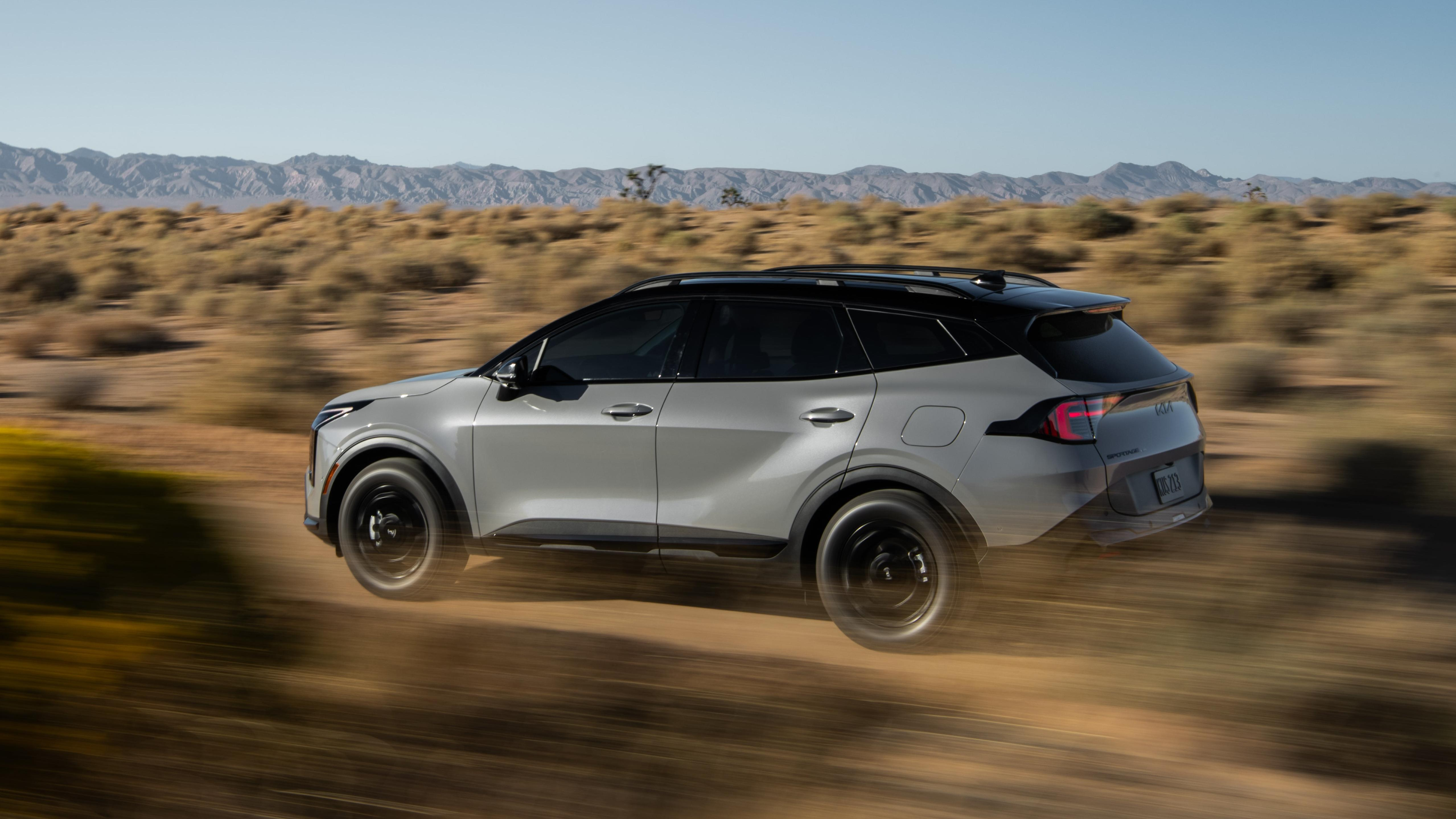 A 2026 Kia Sportage driving off-road in a desert