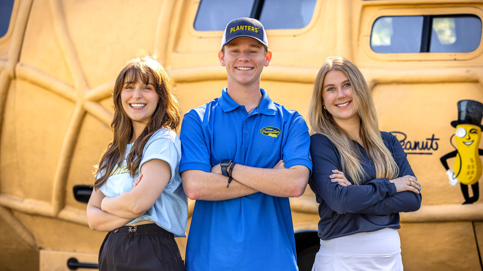 A photo of three of the current Peanutters in front of the Nutmobile