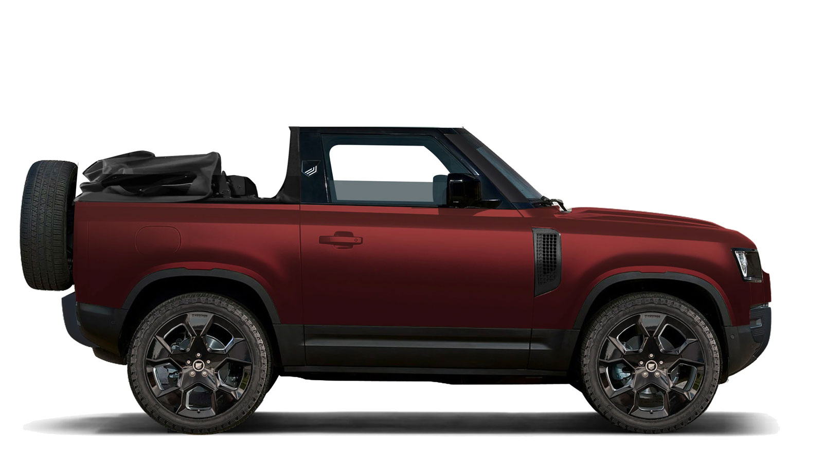 A red Land Rover Defender with a convertible roof. 