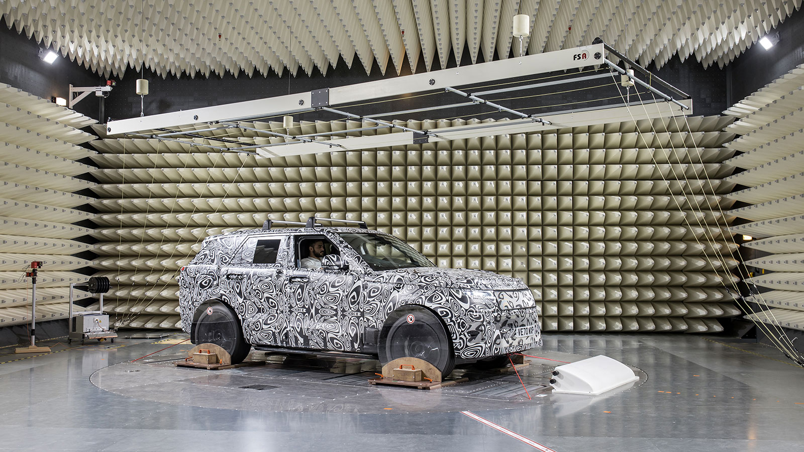 A photo of a Land Rover car testing in a spiky room. 