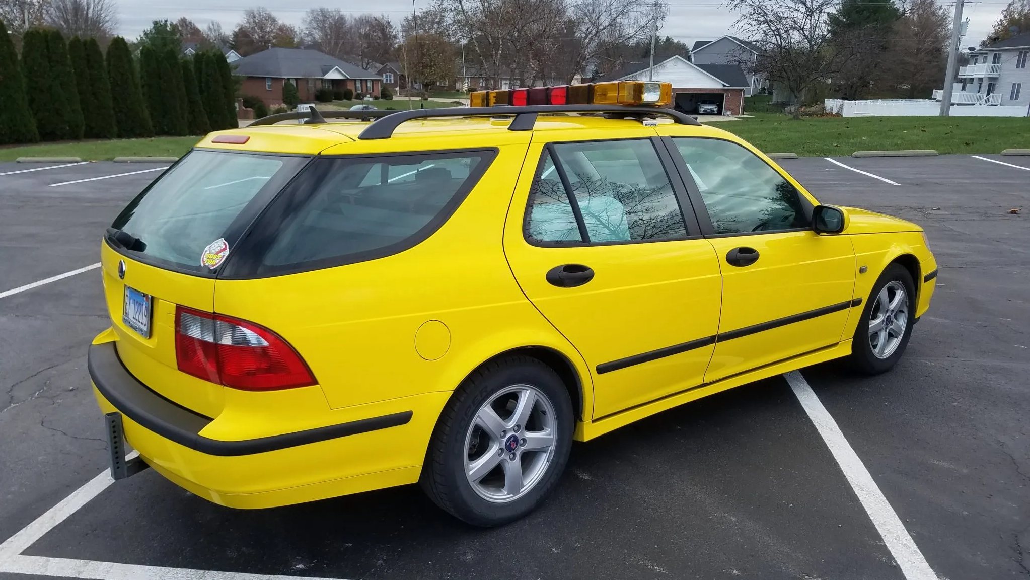 a rear shot of the bright yellow saab 9-5