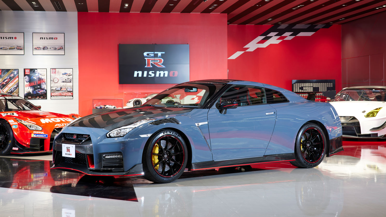 A Nissan GT-R with blue bodywork and exposed carbon fibre details 