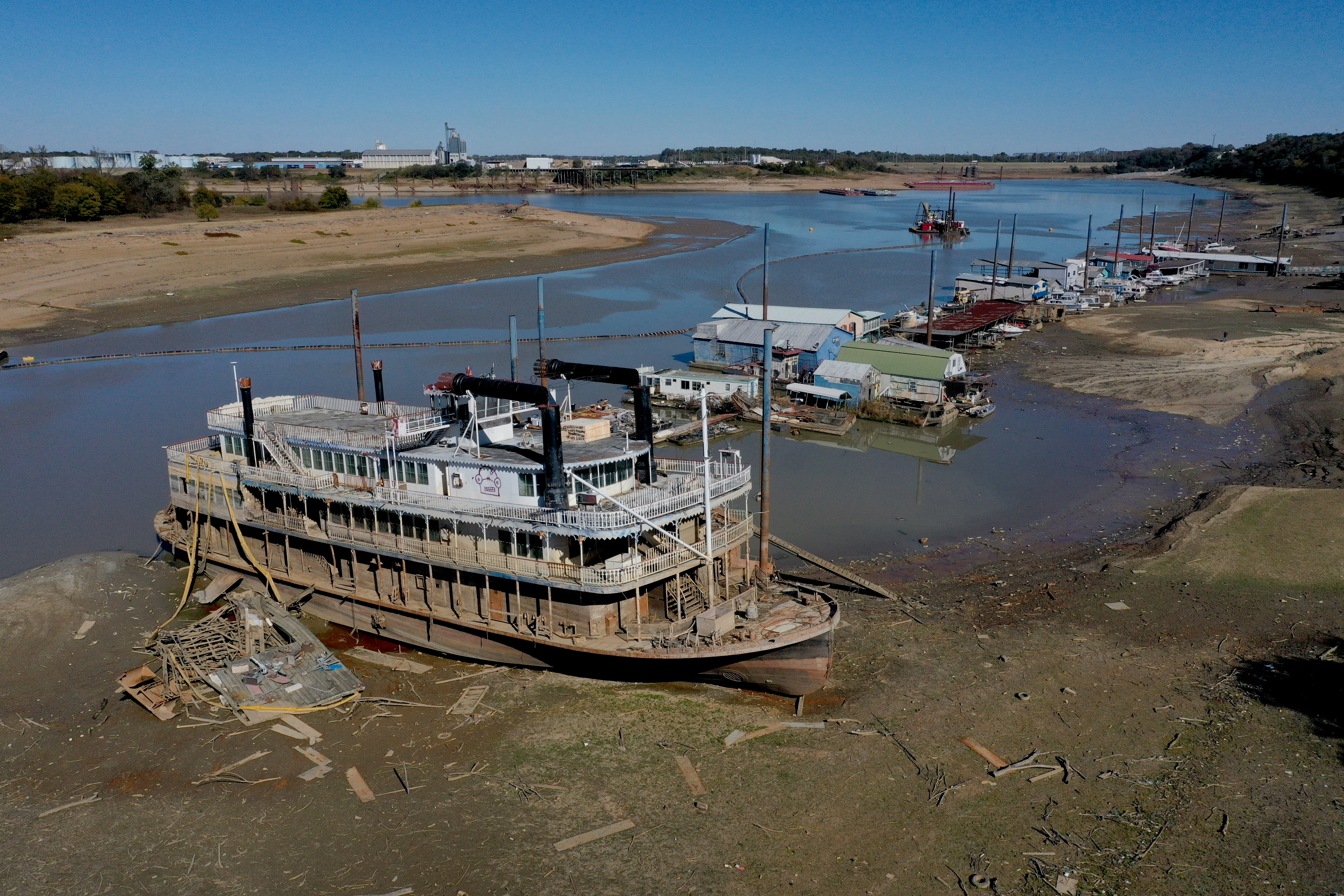 The Diamond Lady, a once majestic riverboat, rests with smaller boats in mud at Riverside Park Marina in Martin Luther King Jr. Riverside Park along the Mississippi River on October 19, 2022 in Memphis, Tennessee. Lack of rain in the Ohio River Valley and along the Upper Mississippi has the Mississippi River south of the confluence of the Ohio River nearing record low levels which is wreaking havoc at marinas, and with barge traffic, driving up shipping prices and threatening crop exports and fertilizer shipments as the soybean and corn harvest gets into full swing.