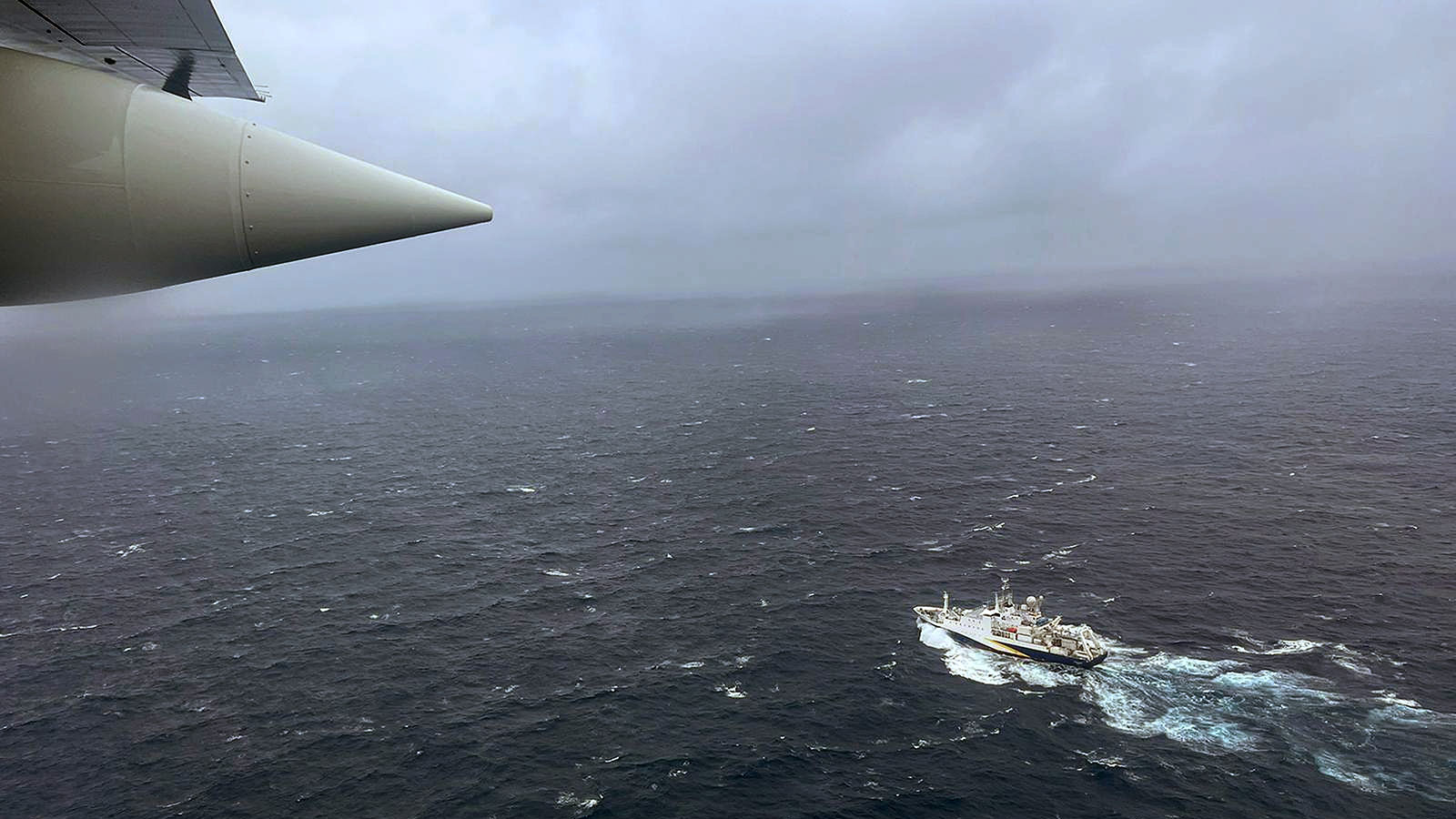 A photo taken from the air by the Coast Guard of a search ship in the water. 