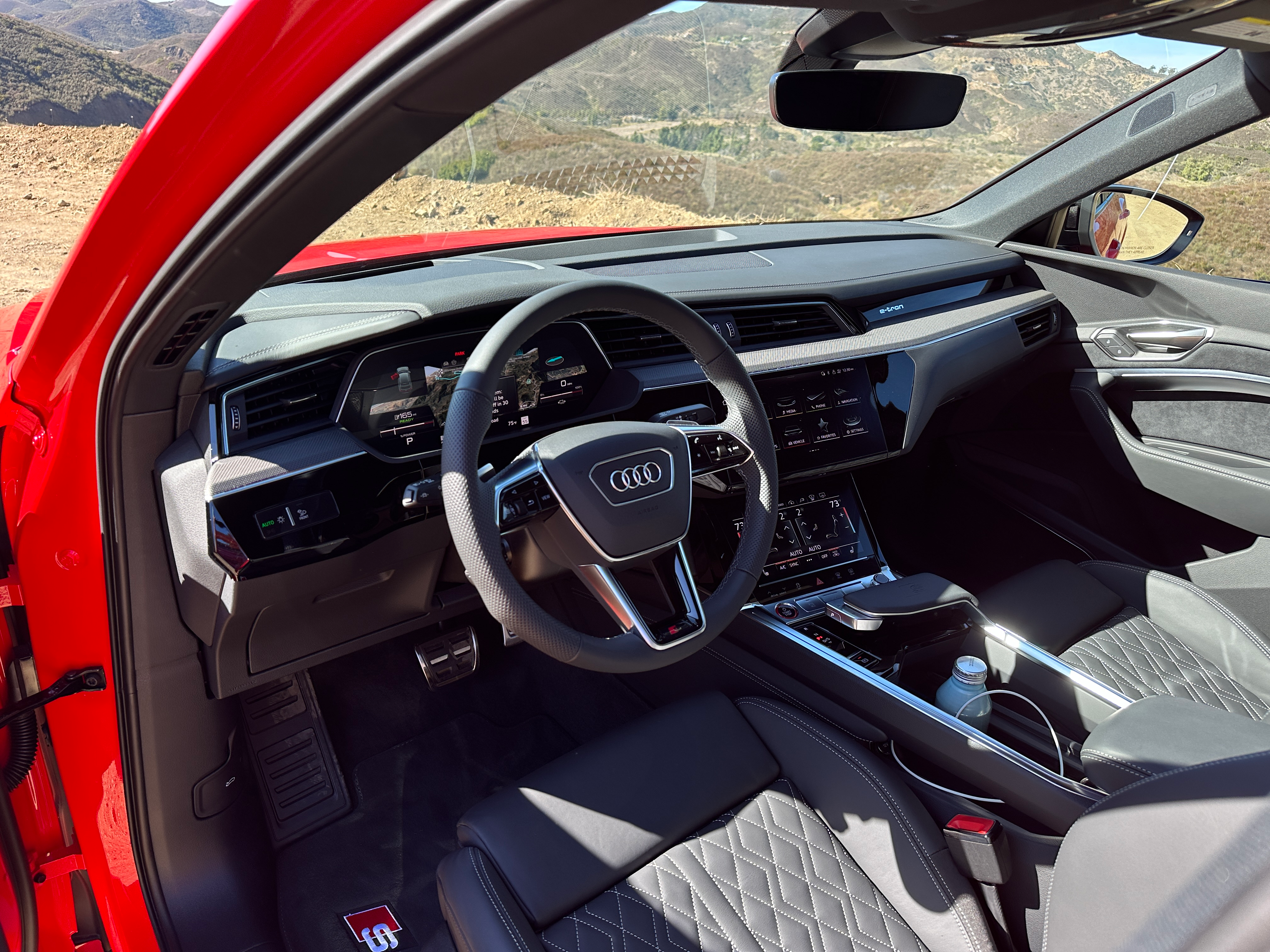 Photo showing the dashboard and interior of an Audi SQ8 E-Tron Sportback with black leather