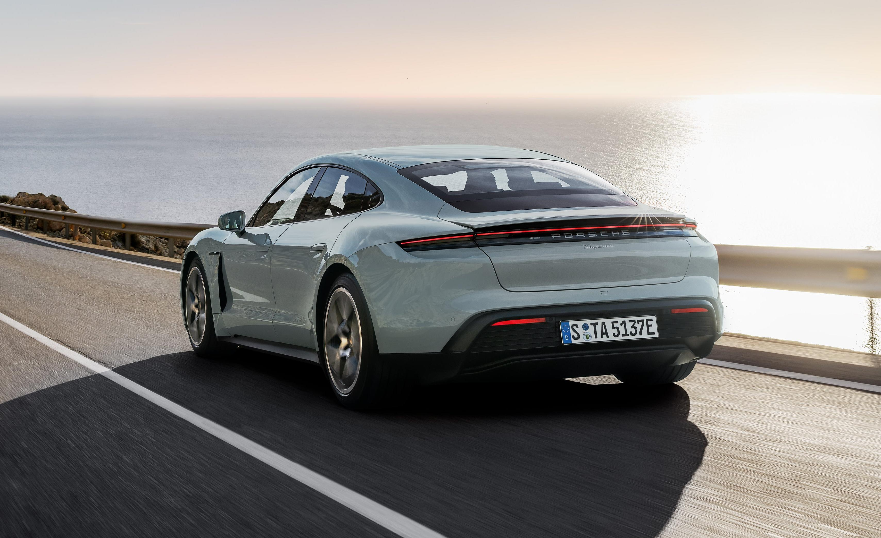 Rear 3/4 view of a light green 2025 Porsche Taycan sedan