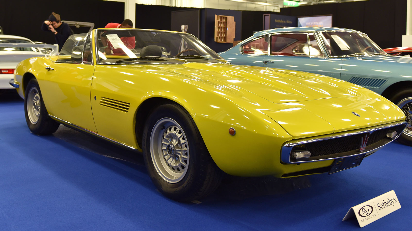 A photo of a yellow Maserati Ghibli Spyder 