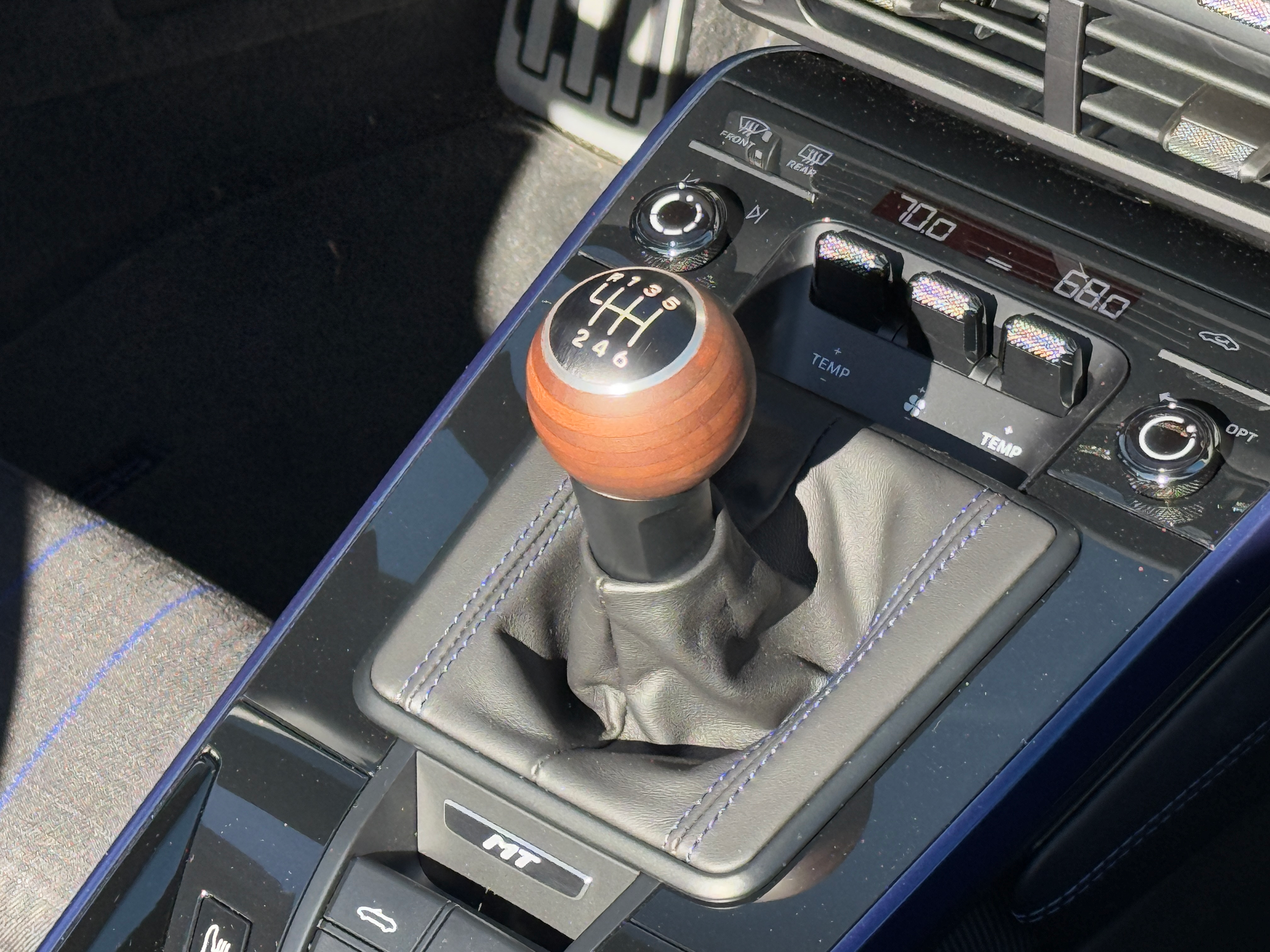 Wood shift knob of a blue 2025 Porsche 911 Carrera T cabriolet