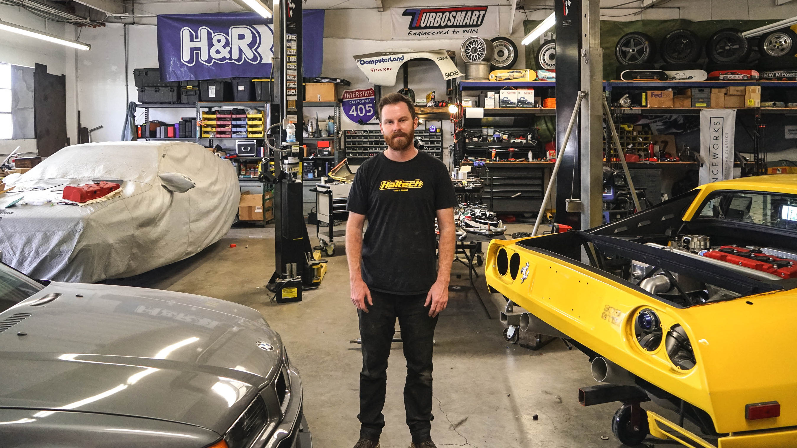 Mike Burroughs stands in the midst of a messy shop.