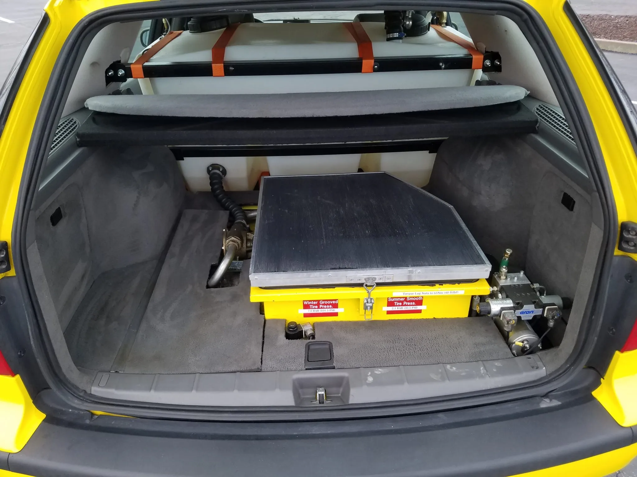 the trunk of the 9-5 showing the giant water tank in place of the rear seat and other measurement equipment 