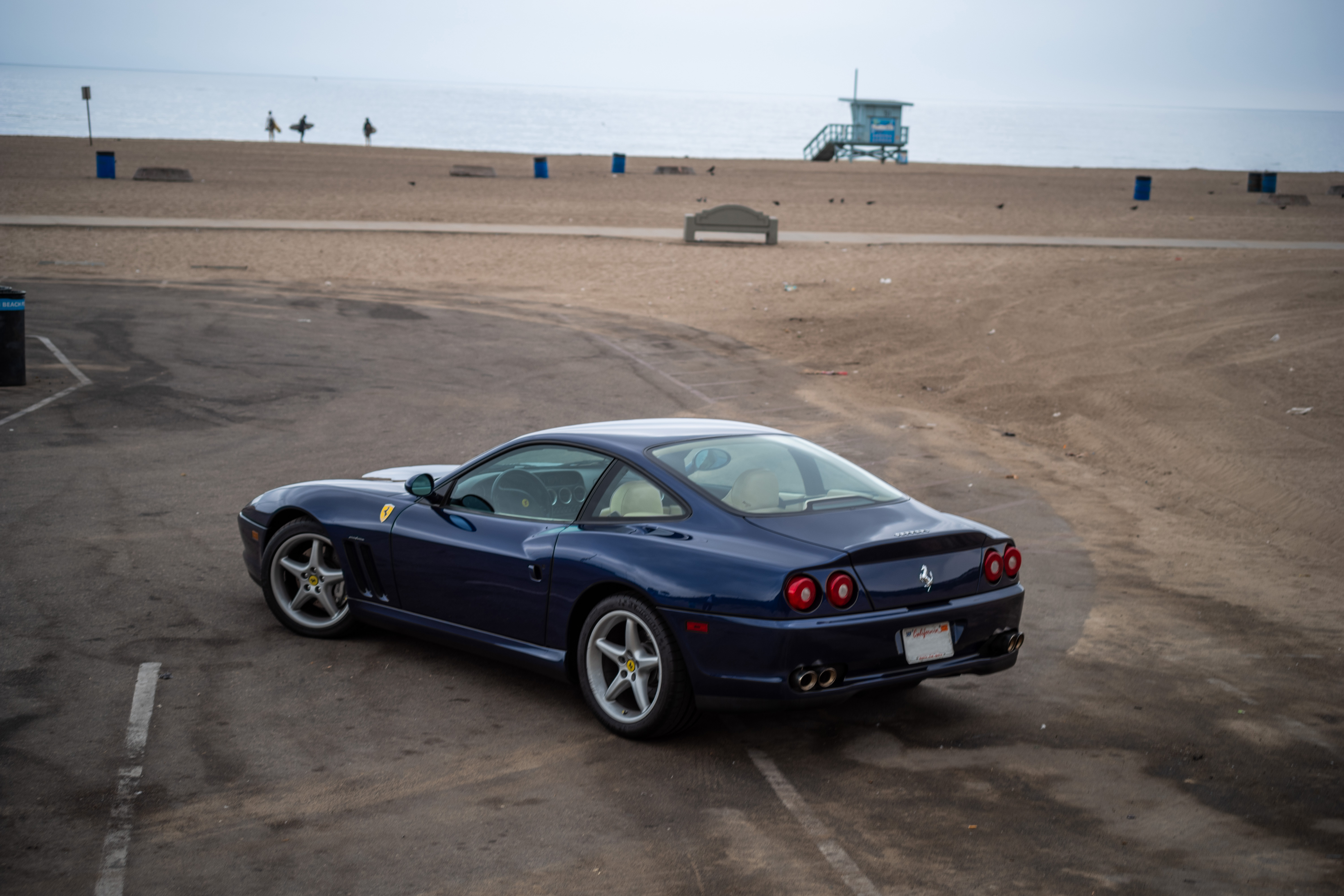 Rear three-quarter view of a blue 1999 Ferrari 550 Maranello