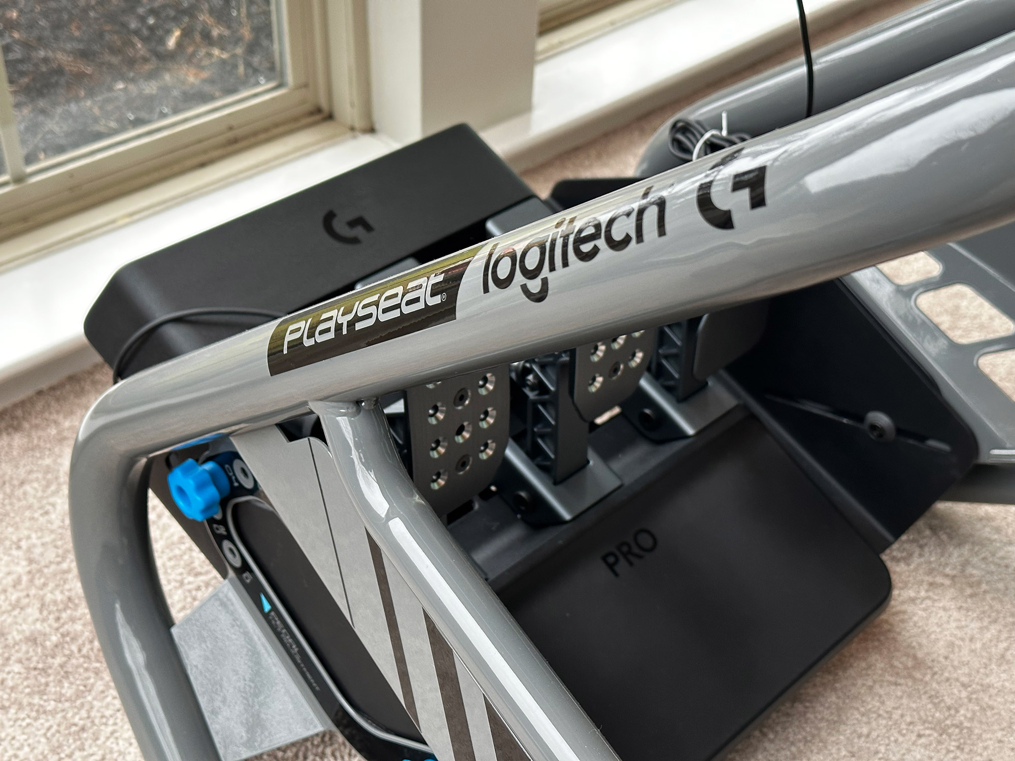 Close-up of side rail and pedals attached to Playseat Trophy Logitech G Edition.