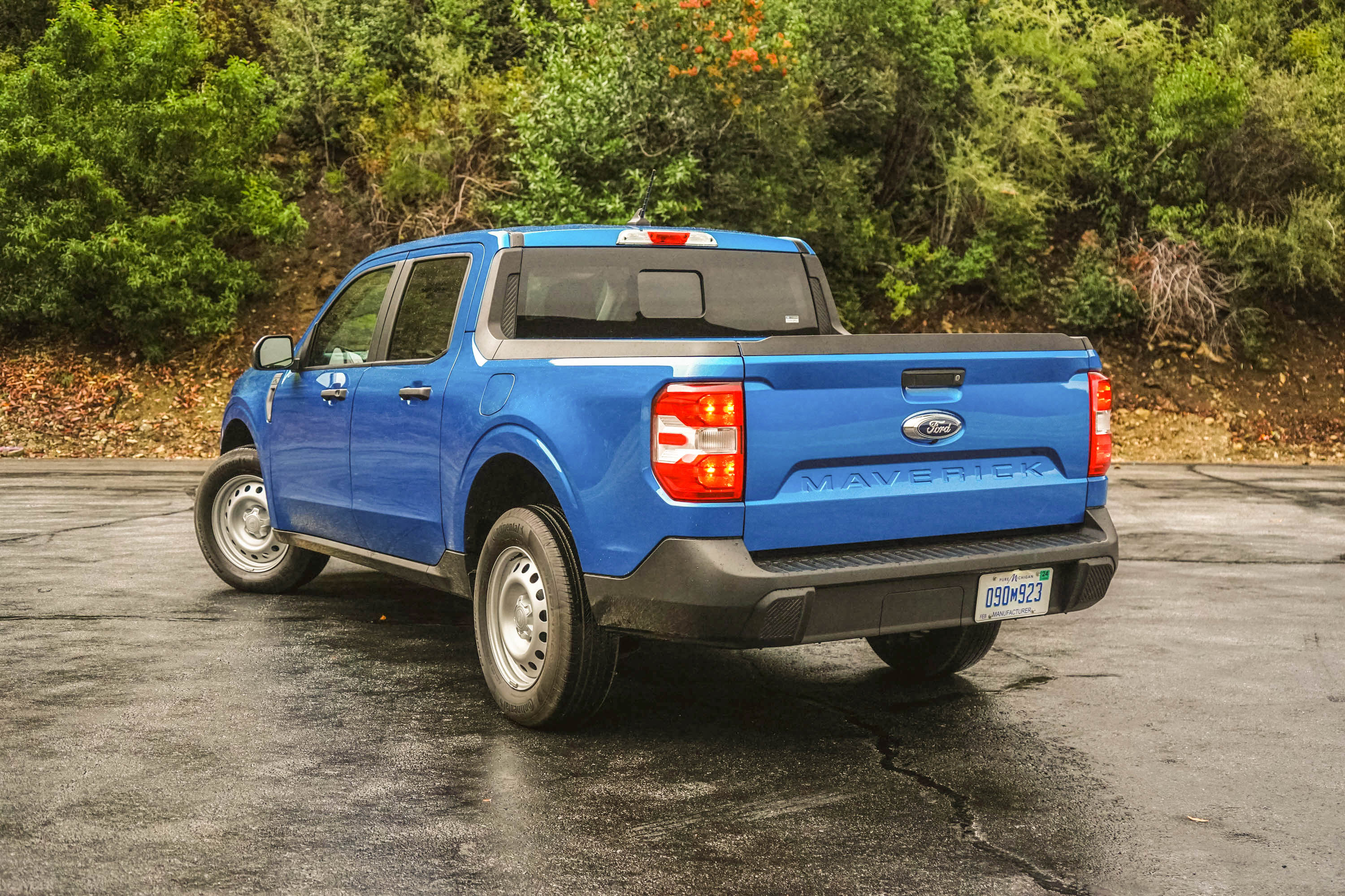 The rear three-quarter view of the 2023 Ford Maverick XL in blue.