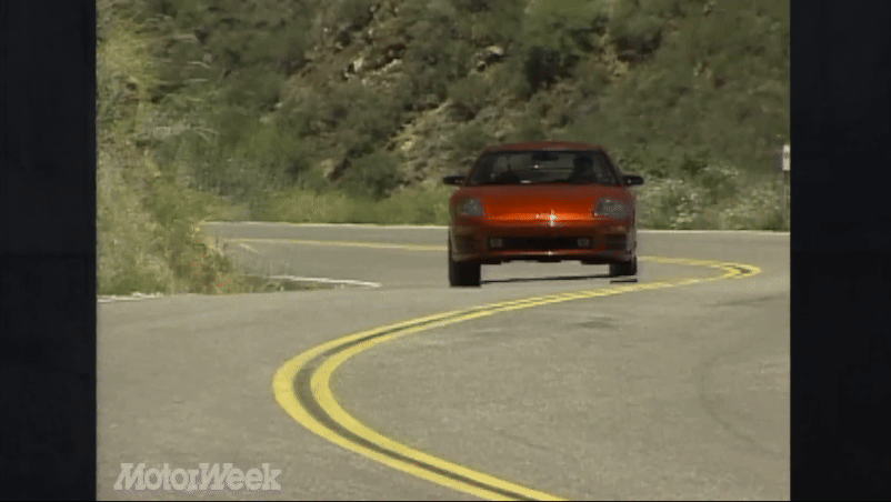 A gif from the motorweek review showing a red 2000 Eclipse driving on a curvy road