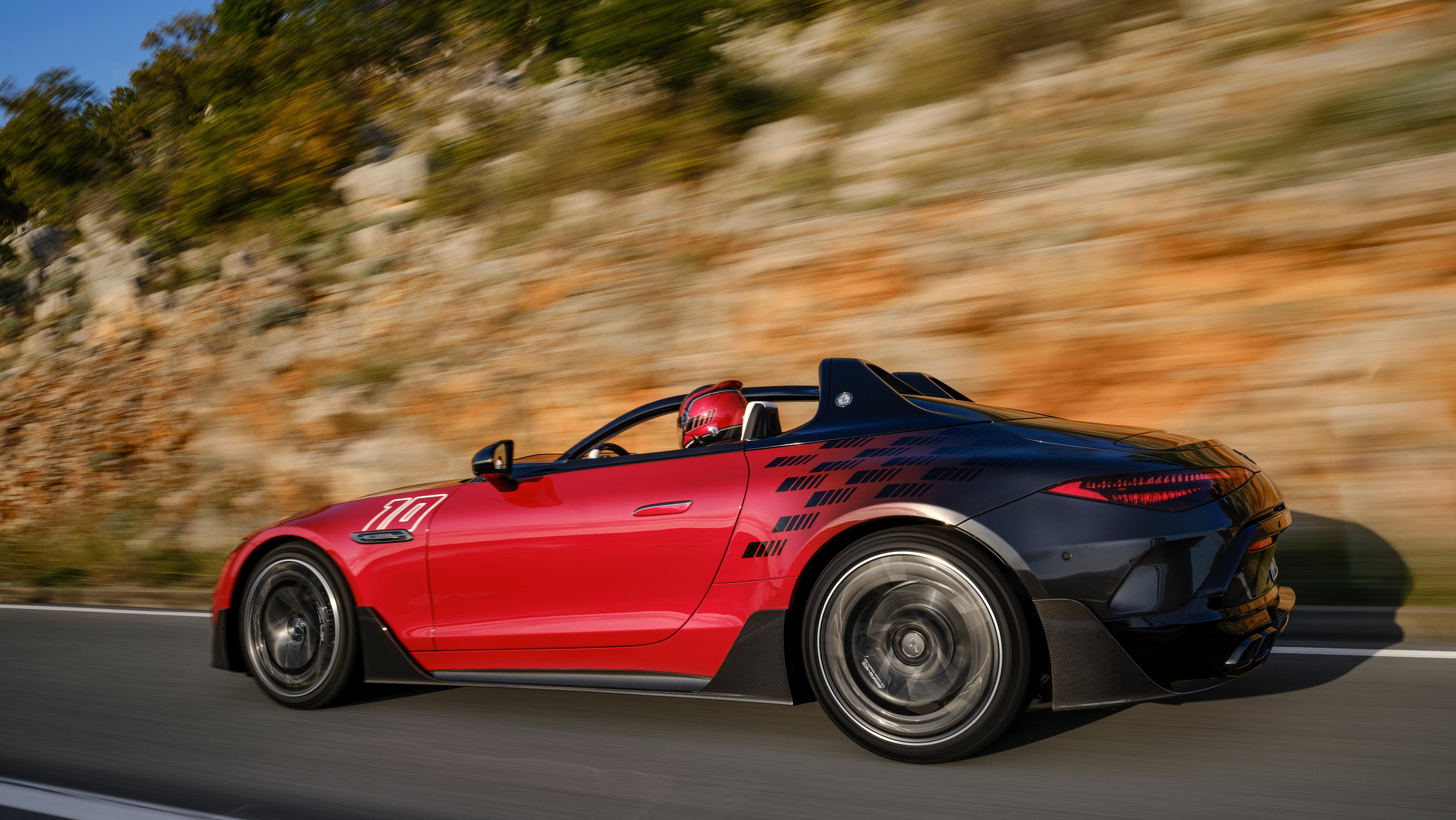 A rear three quarters shot of the PureSpeed driving in front of a mountain