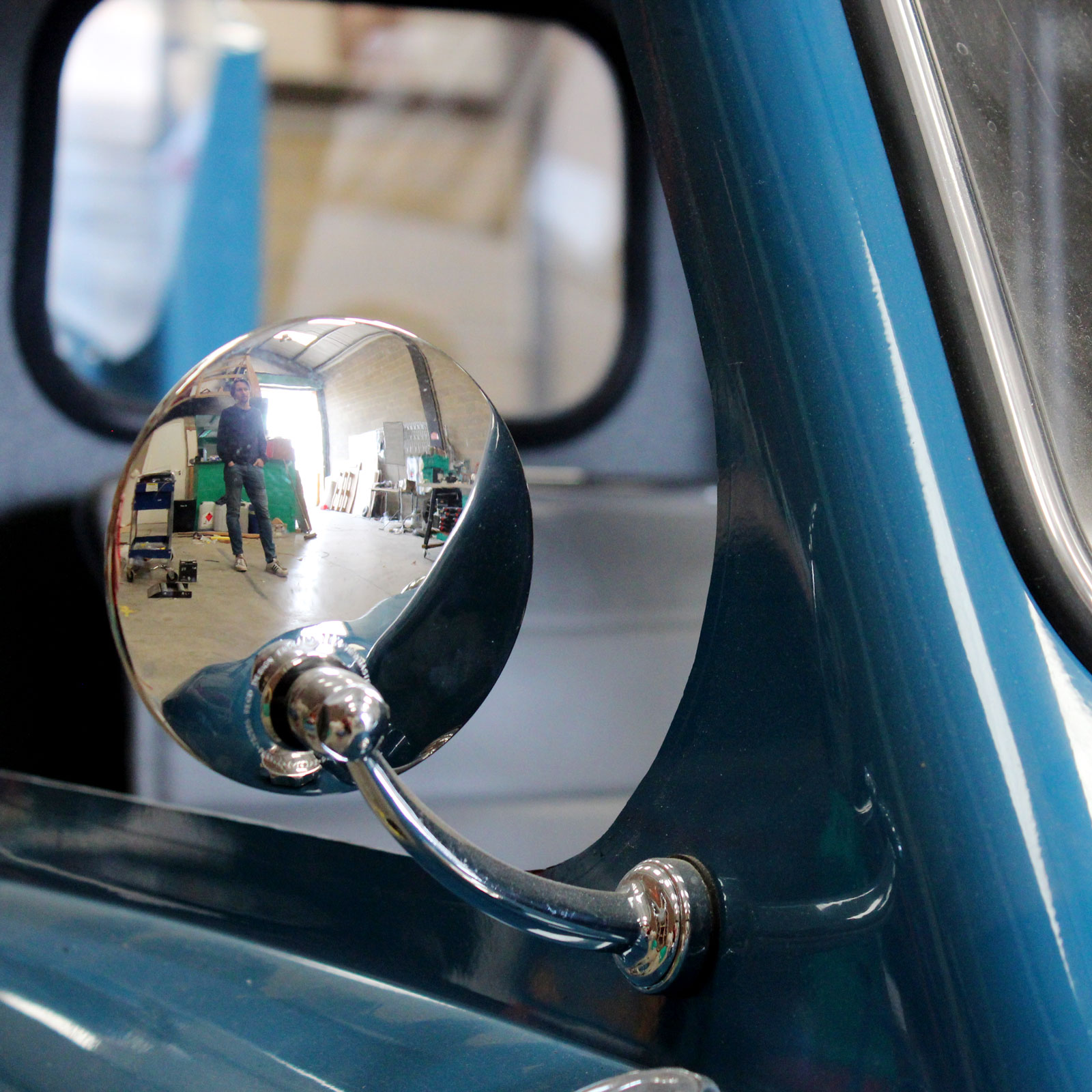 A close up photo of the mirror on a P50 Cars replica. 