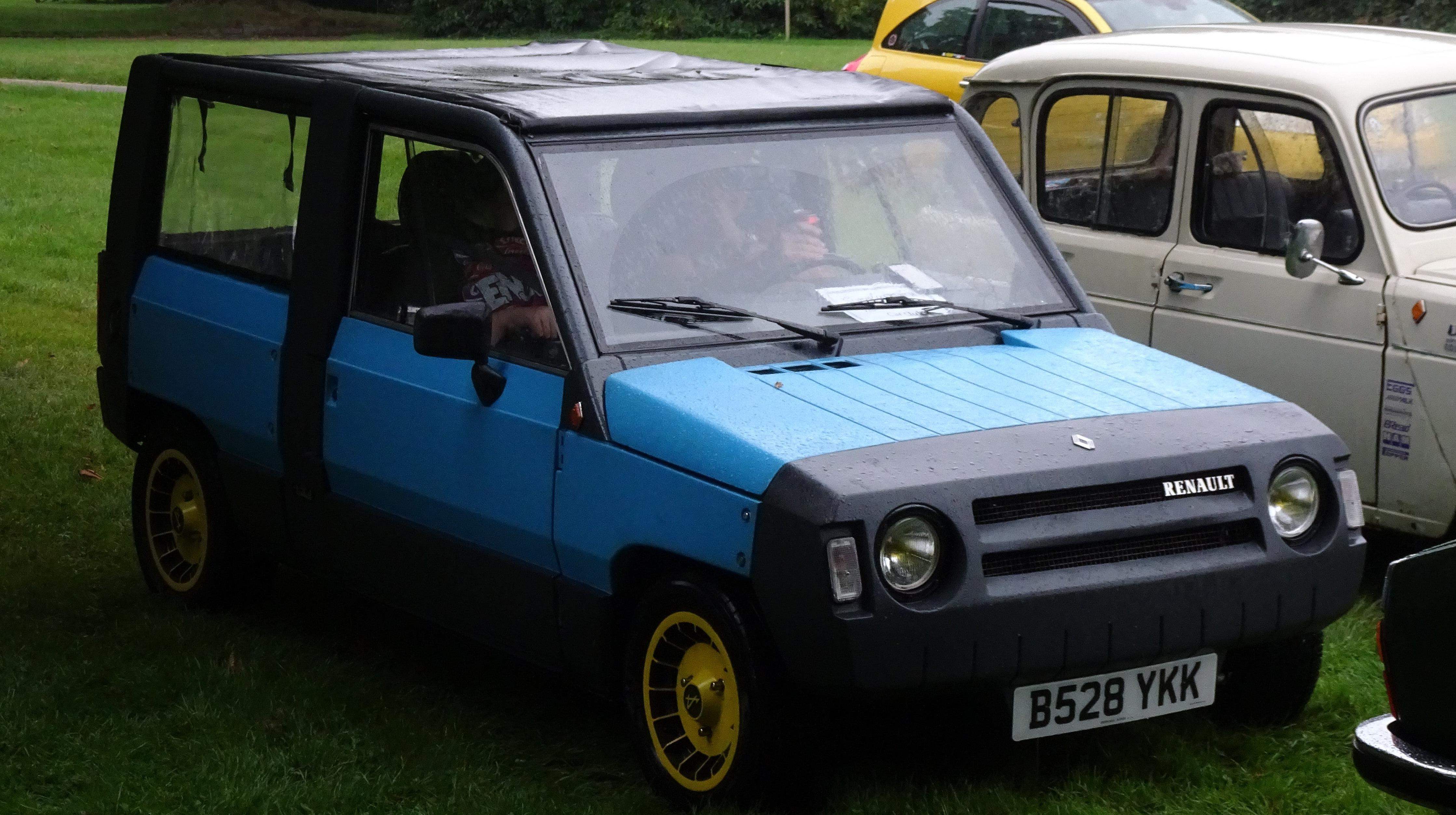 A turquoise Rodeo 5 parked on grass