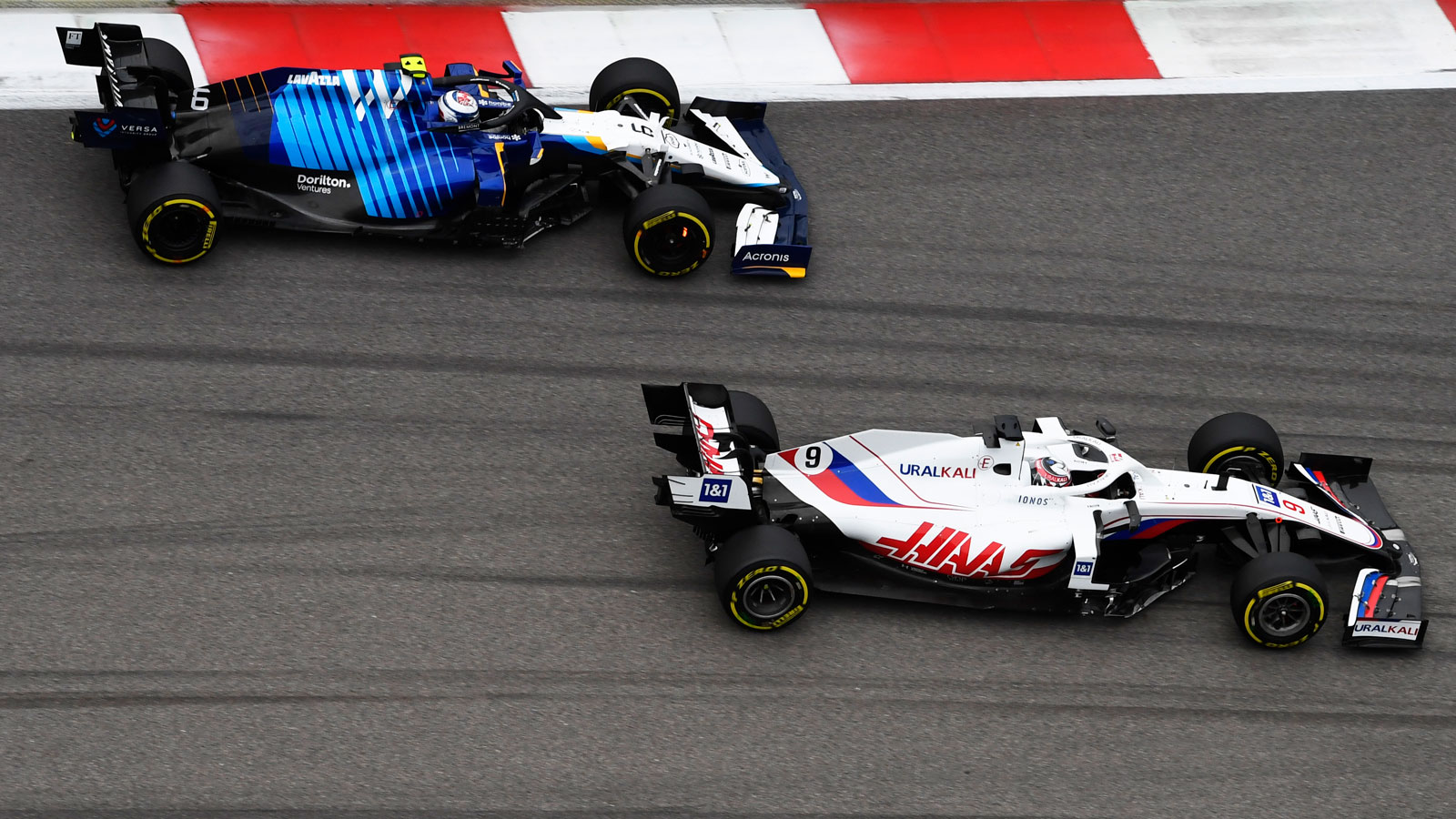 A photo of Haas driver Nikita Mazepin overtaking Williams' Nicholas Latiffi. 