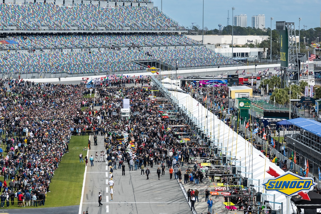 Massive crrowds gather in the pits and the banking near the starting stand for pre-race grid walk.