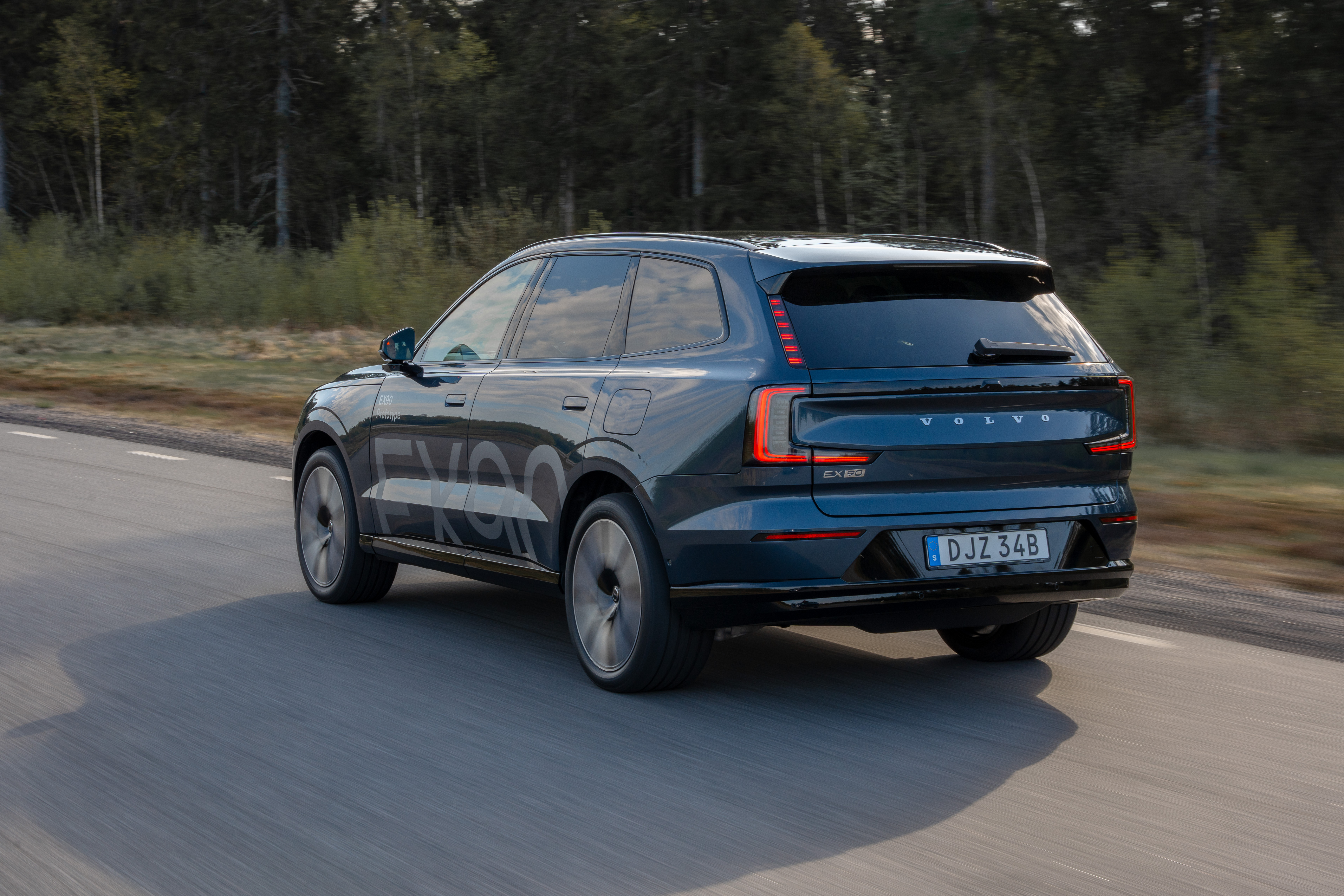 Rear 3/4 view of a blue Volvo EX90