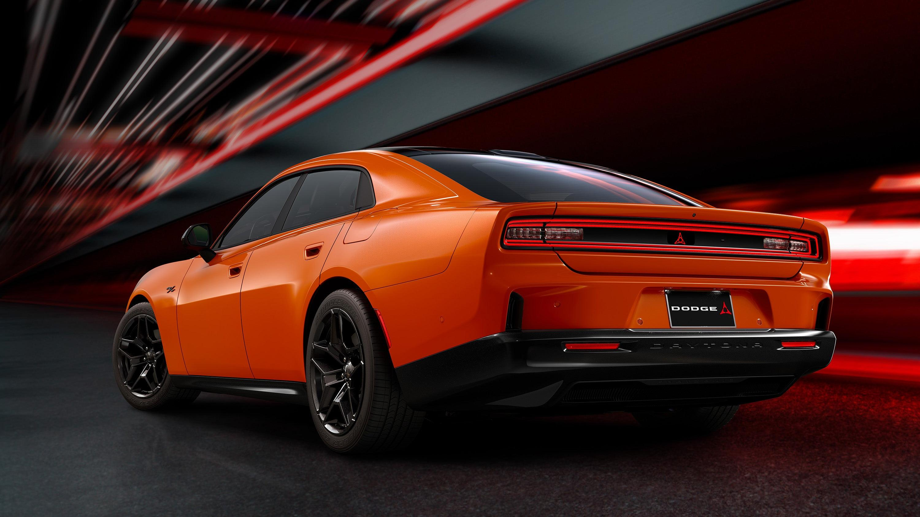 Rear 3/4 view of an orange four-door 2024 Dodge Charger Daytona EV