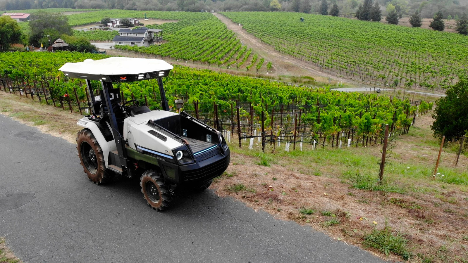 A photo of a Monarch Tractor overlooking a vineyard. 