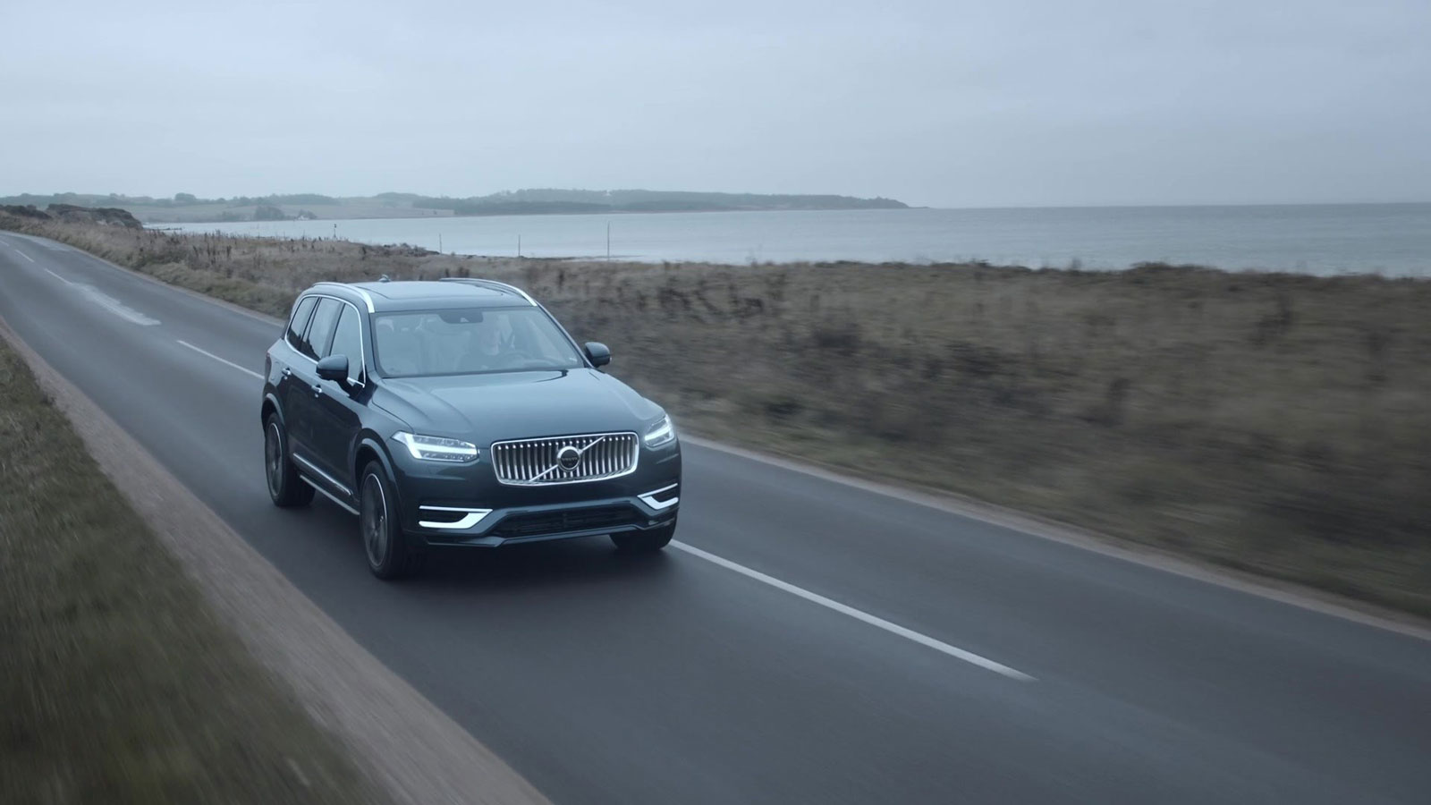 A photo of a Volvo XC90 SUV on a road. 