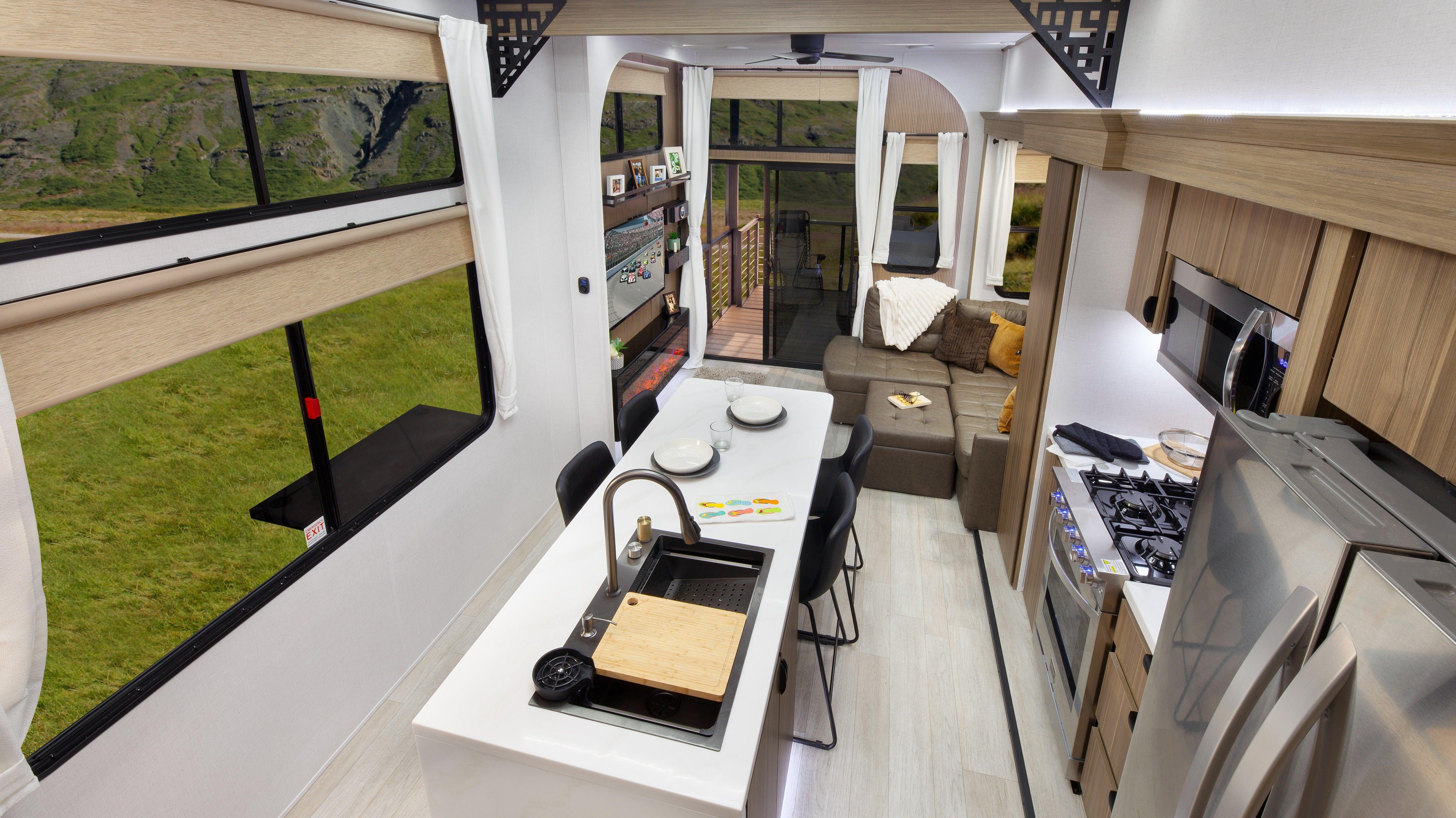 A photo of the interior of the trailer showing the kitchen island and the living area