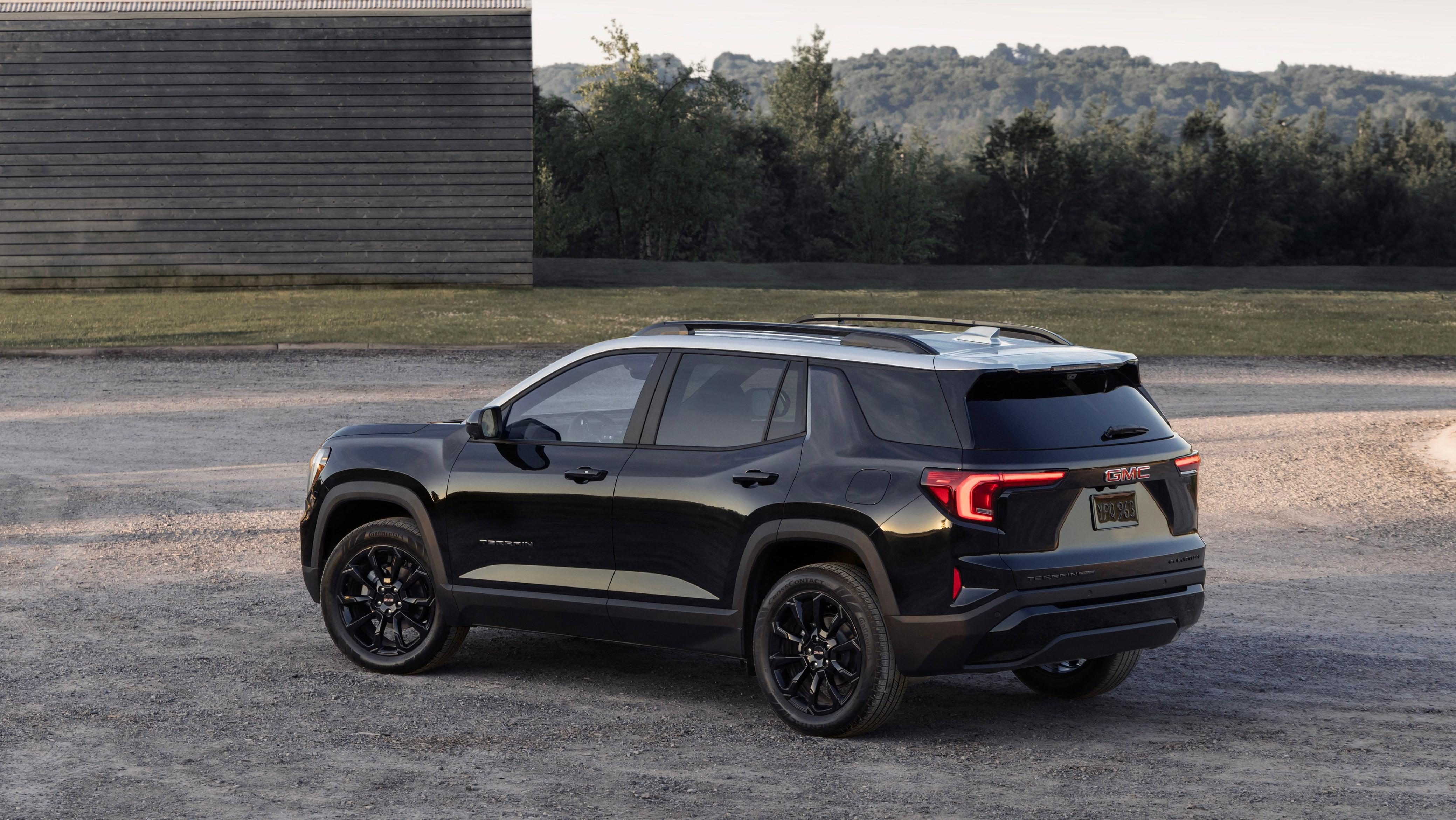 A rear 3/4 shot of a black terrain with a white roof 