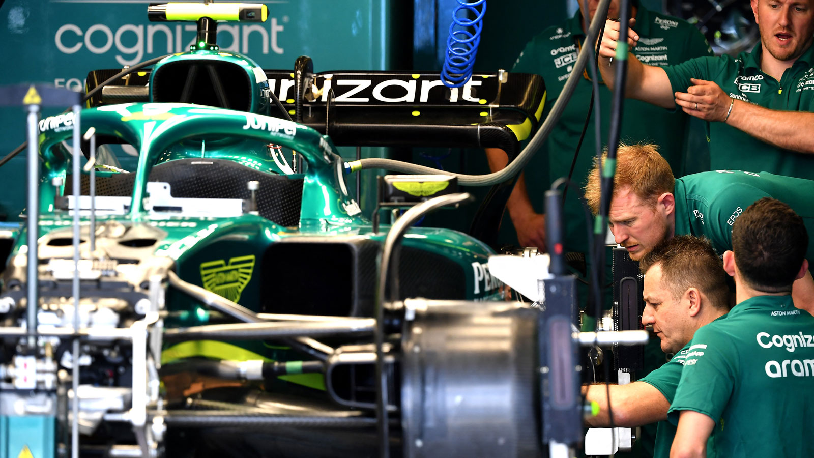 Mechanics work to rebuild an Aston Martin F1 car. 