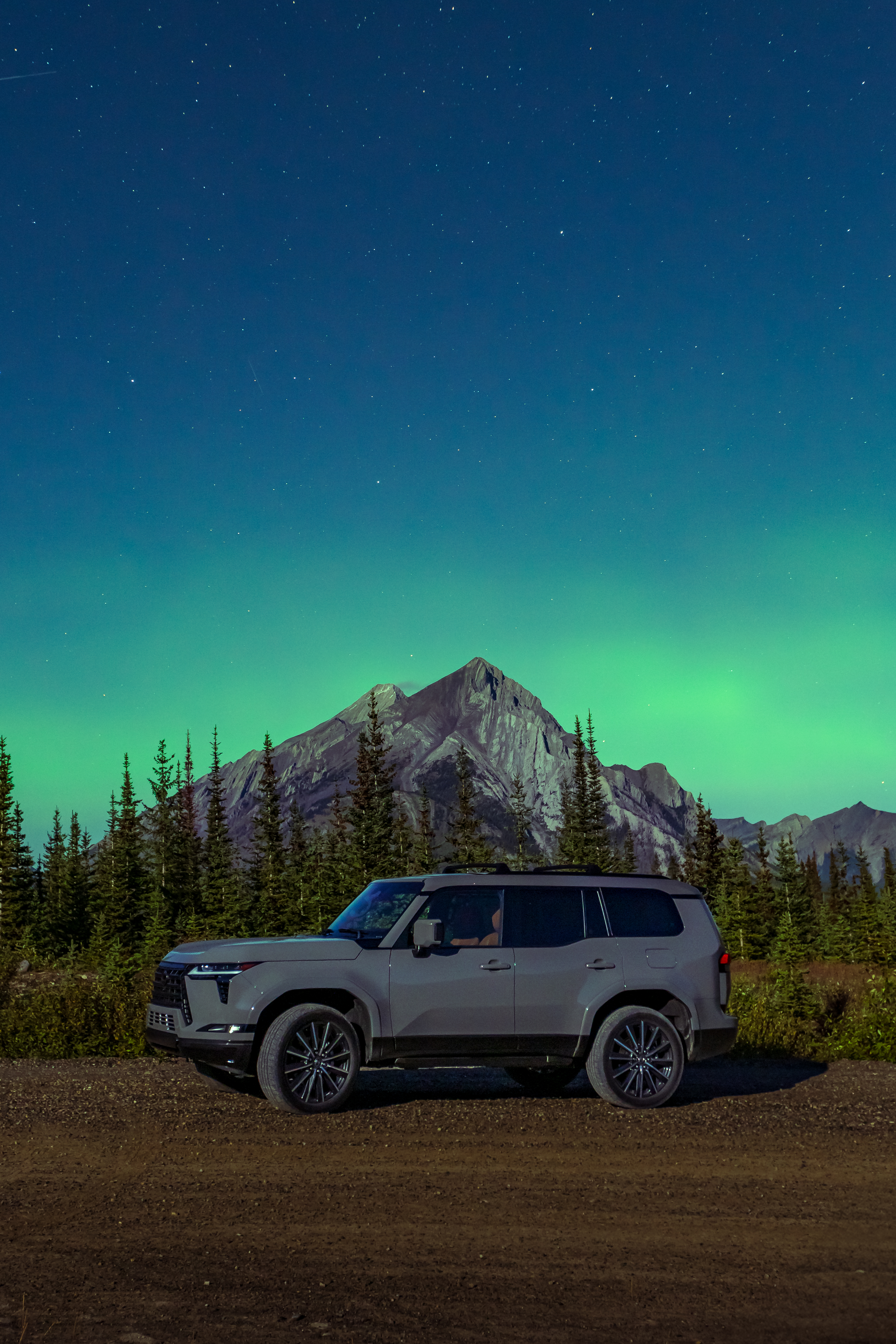 Side view of a Lexus GX 550 with the northern lights in the background