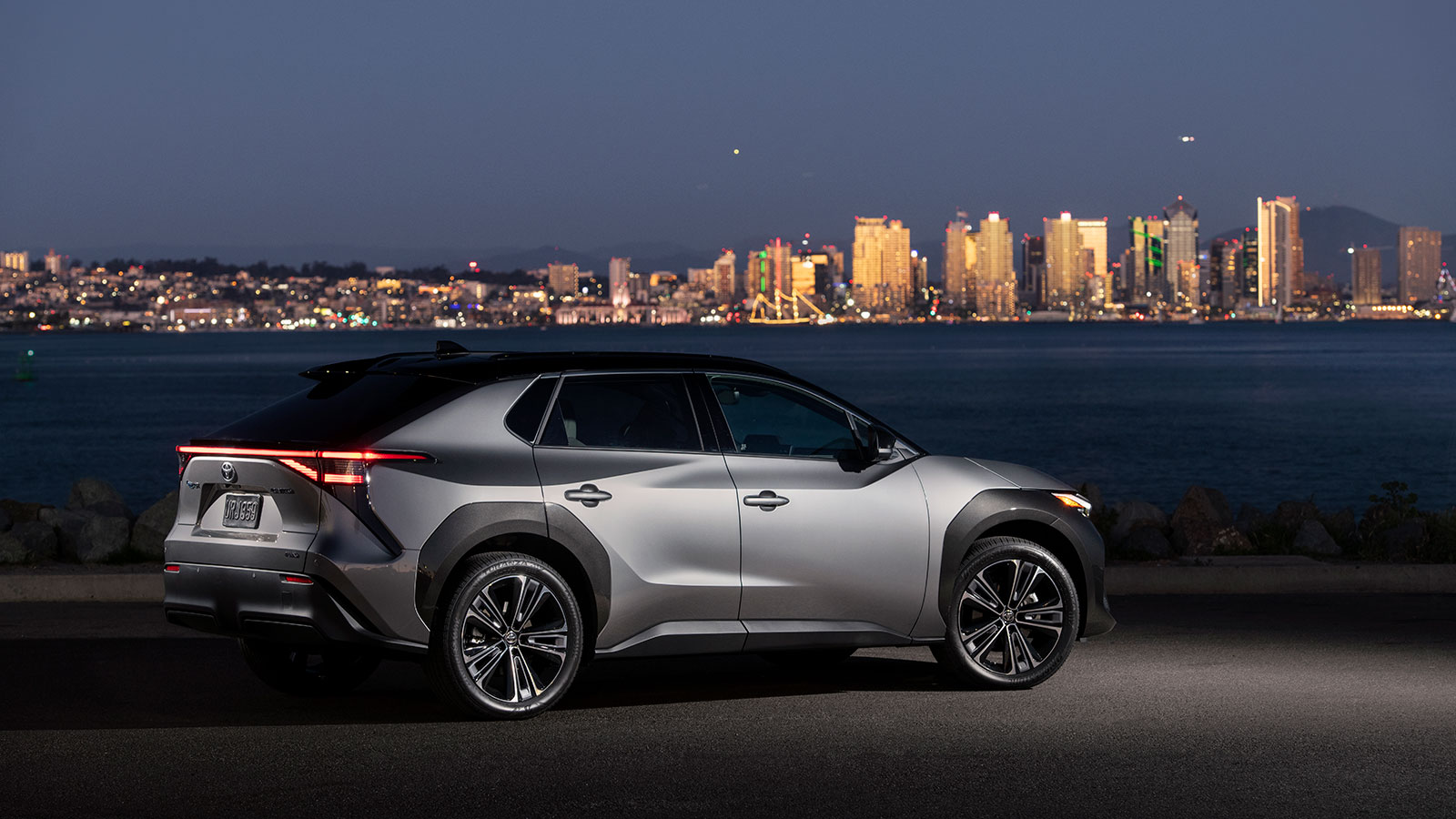 A photo of a Toyota bZ4x electric SUV at night. 