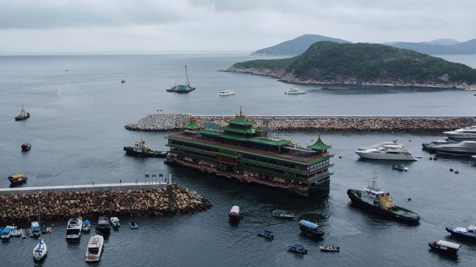 A photo of the Jumbo Kingdom floating restaurant being towed out to sea. 