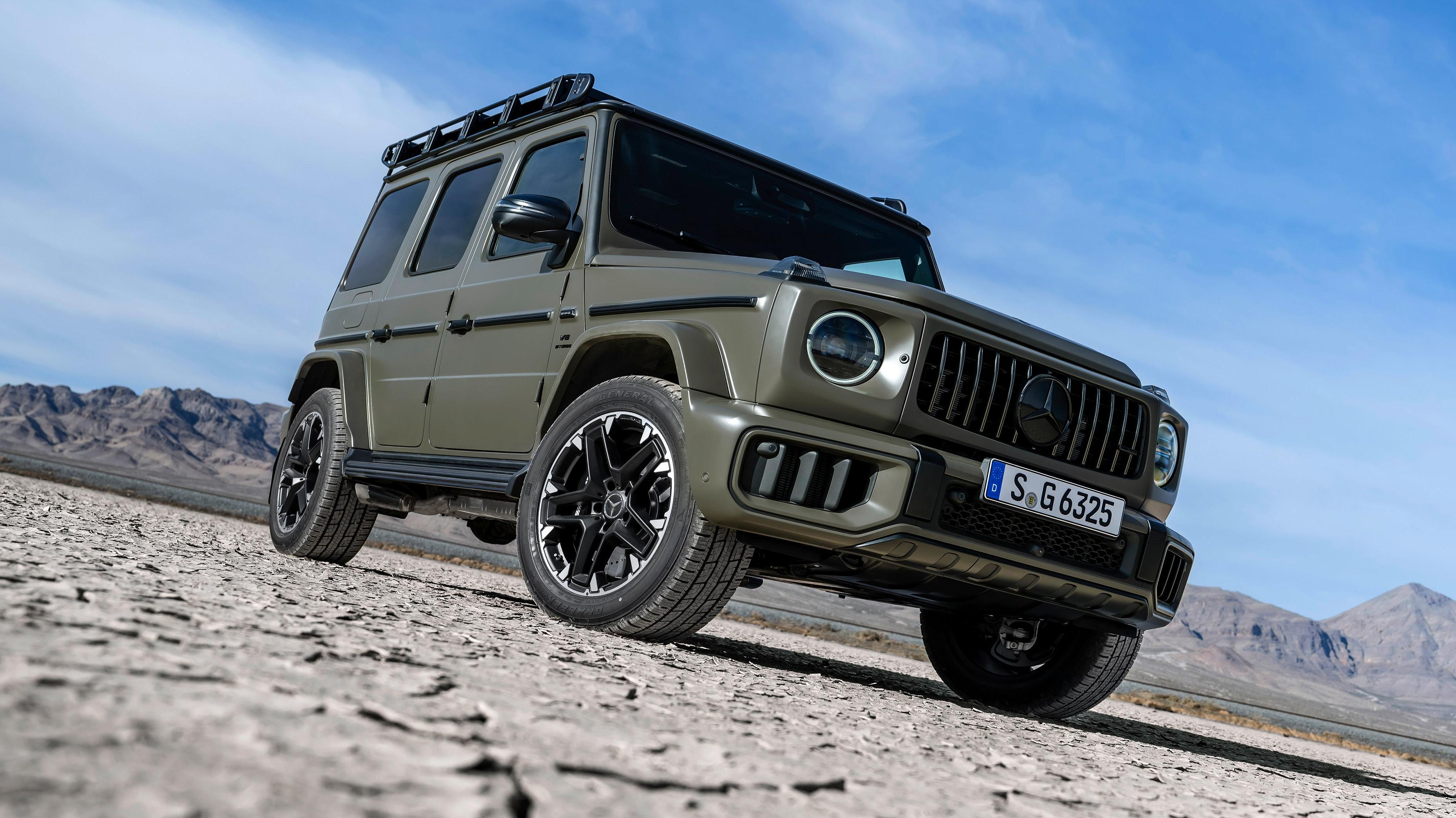 Front 3/4 view of a Dark Olive Green Magno 2025 Mercedes-AMG G63