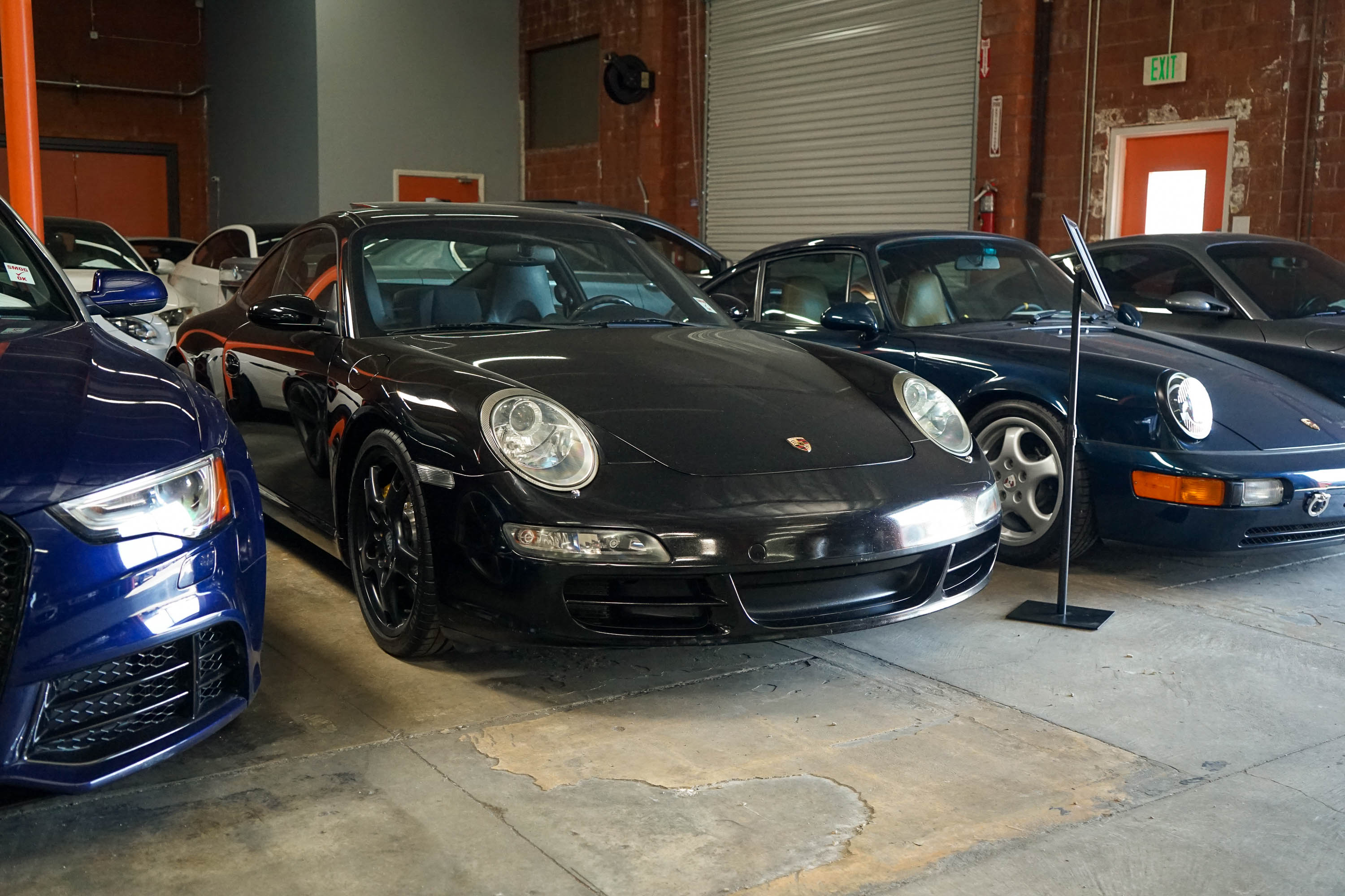 Black 911 inside a warehouse.