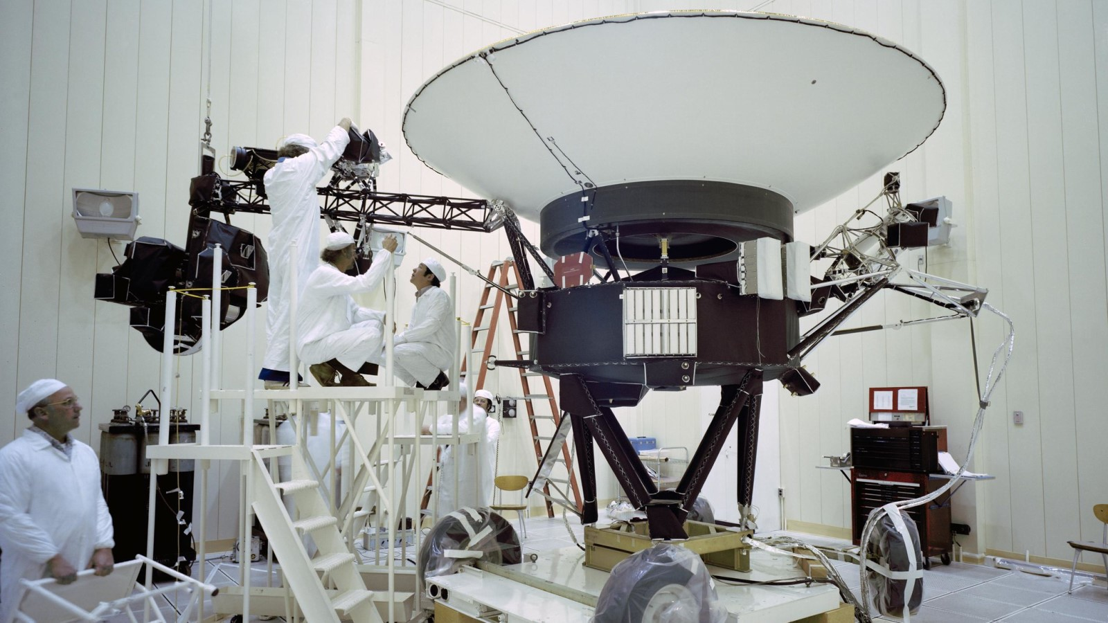 a photo of engineers working on the Voyager probe on Earth. 