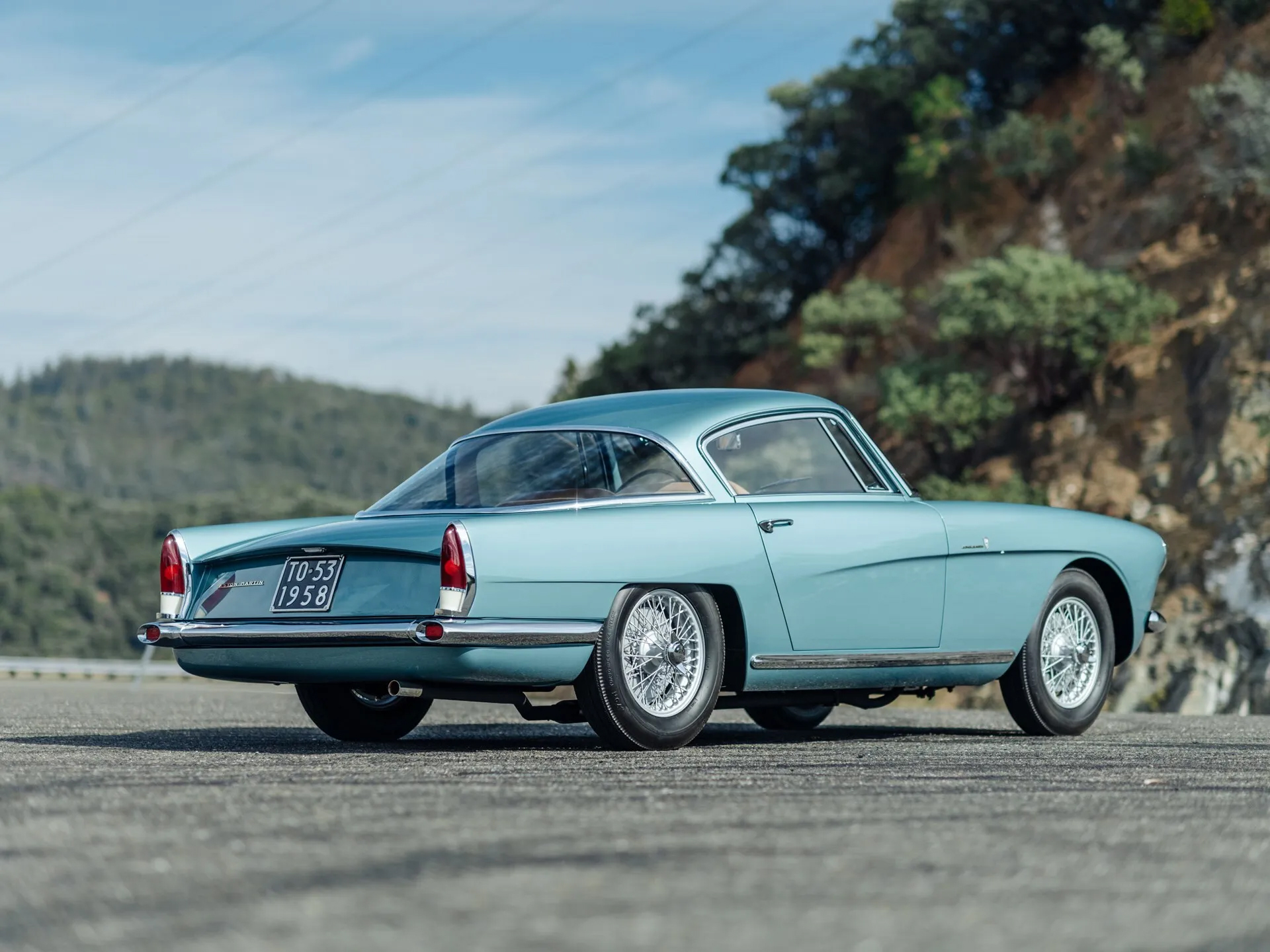 Rear 3/4 view of a teal Aston Martin DB2/4 by Bertone