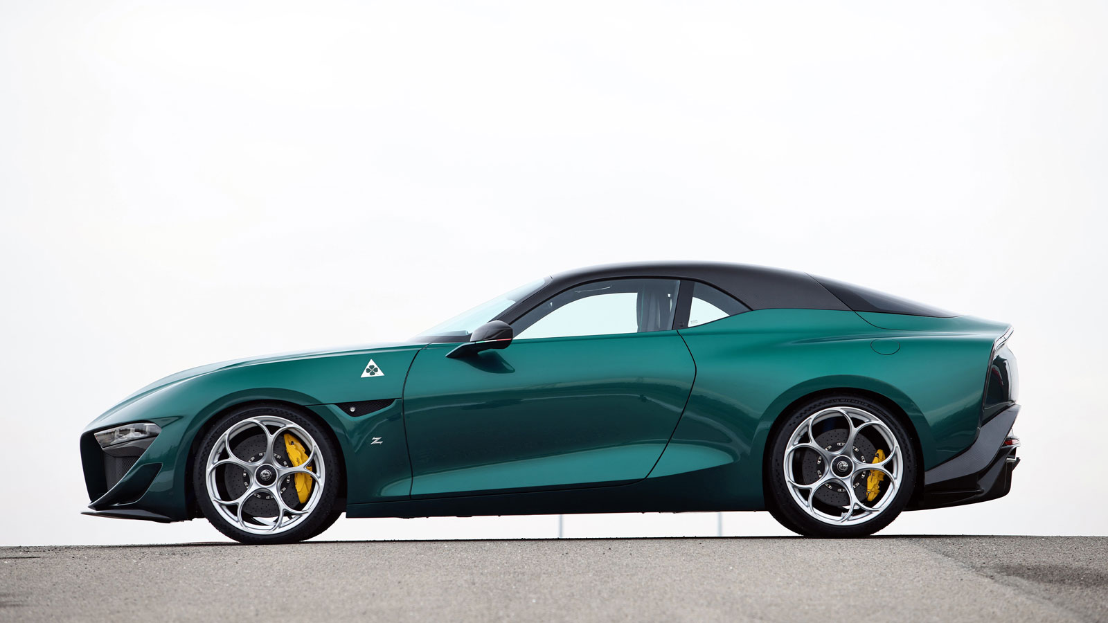 A profile view of the dark green Alfa Romeo Giulia SWB Zagato. 