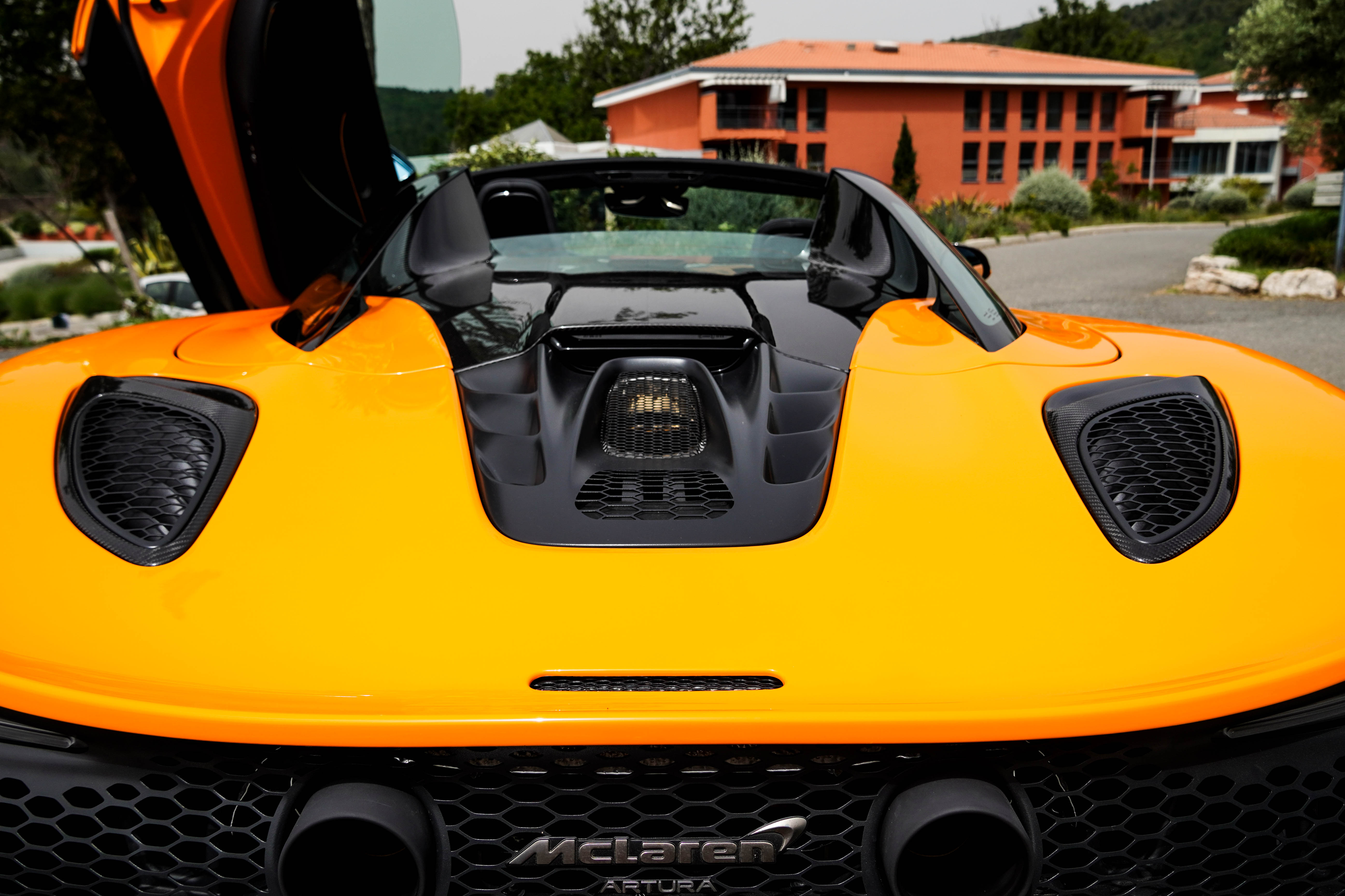 Engine cover of an orange McLaren Artura Spider